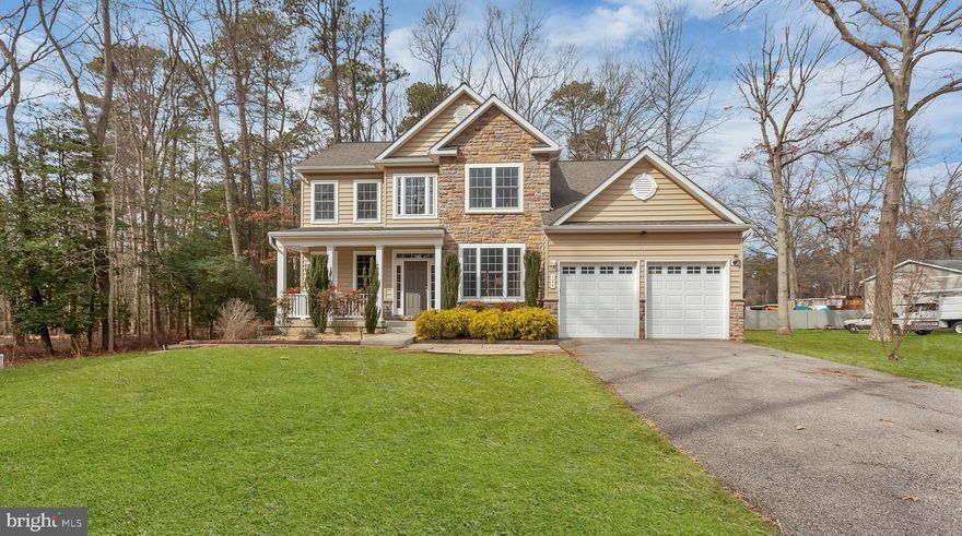 Welcome to this stately 4-bedroom, 2.5-bath Colonial featuring a gorgeous stone front and a welcoming covered porch. Located on 2.5 acres of wooded land, this home combines timeless charm with modern convenience, offering an ideal space for both relaxing and entertaining.
Step inside to a grand two-story foyer with a winding staircase, complemented by 9-foot ceilings and hardwood floors throughout the main level. The open layout includes a bright office, perfect for working from home. The gourmet kitchen is a chef’s dream, boasting an island with a double sink, white maple cabinets with an antique finish, granite countertops, a double wall oven with convection, an electric cooktop, and a built-in microwave. The sunroom off the kitchen offers serene views of the wooded backyard, with sliding doors leading to a spacious rear deck—perfect for enjoying nature's beauty.
Host gatherings in the formal dining room with elegant chair railing, or unwind in the cozy family room featuring a gas fireplace. The main level also includes a convenient laundry room and an oversized 2-car attached garage with openers and remotes.
Upstairs, the luxurious master suite awaits with vaulted ceilings, crown molding, a separate sitting room, and a generous walk-in closet. The master bath features ceramic tile flooring, a double vanity, a walk-in shower with ceramic tile surround, and a relaxing soaking tub. The remaining bedrooms all offer hardwood floors and ample space.
The unfinished basement presents endless opportunities, with a rough-in for a future bathroom and a walkout door to the backyard. Dual-zoned heating and cooling ensure year-round comfort.
This home is a true gem, combining elegance, functionality, and a peaceful setting. Don’t miss the chance to make it yours!  To access the home you must use the keypad on the front door. Details in Showing Time instructions!