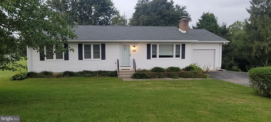 Enjoy quiet country living and this 1.46 acre homesite in this clean & neat 4-Bedroom 2-Bath Ranch Style Home that is sitting waiting and ready for you and your family to move right in!  Come take a look and you will see just how very well this home and land has been  maintained !  New Roof just 2 years ago.  Newer Vinyl siding, replacement windows, well tank, converted gas log fireplace and numerous  other upgrades.  Outside you will find a lush green yard area dotted with Chestnut, Black Walnut, Maple, Mulberry, Fir, and Holly trees.  Along with Lilacs, a Grape Arbor, and an Asparagus Bed.  Also, lots of open space for back yard barbeques, picnics, reunions, & games!  Or just plain relaxing on the large back deck located off the kitchen!