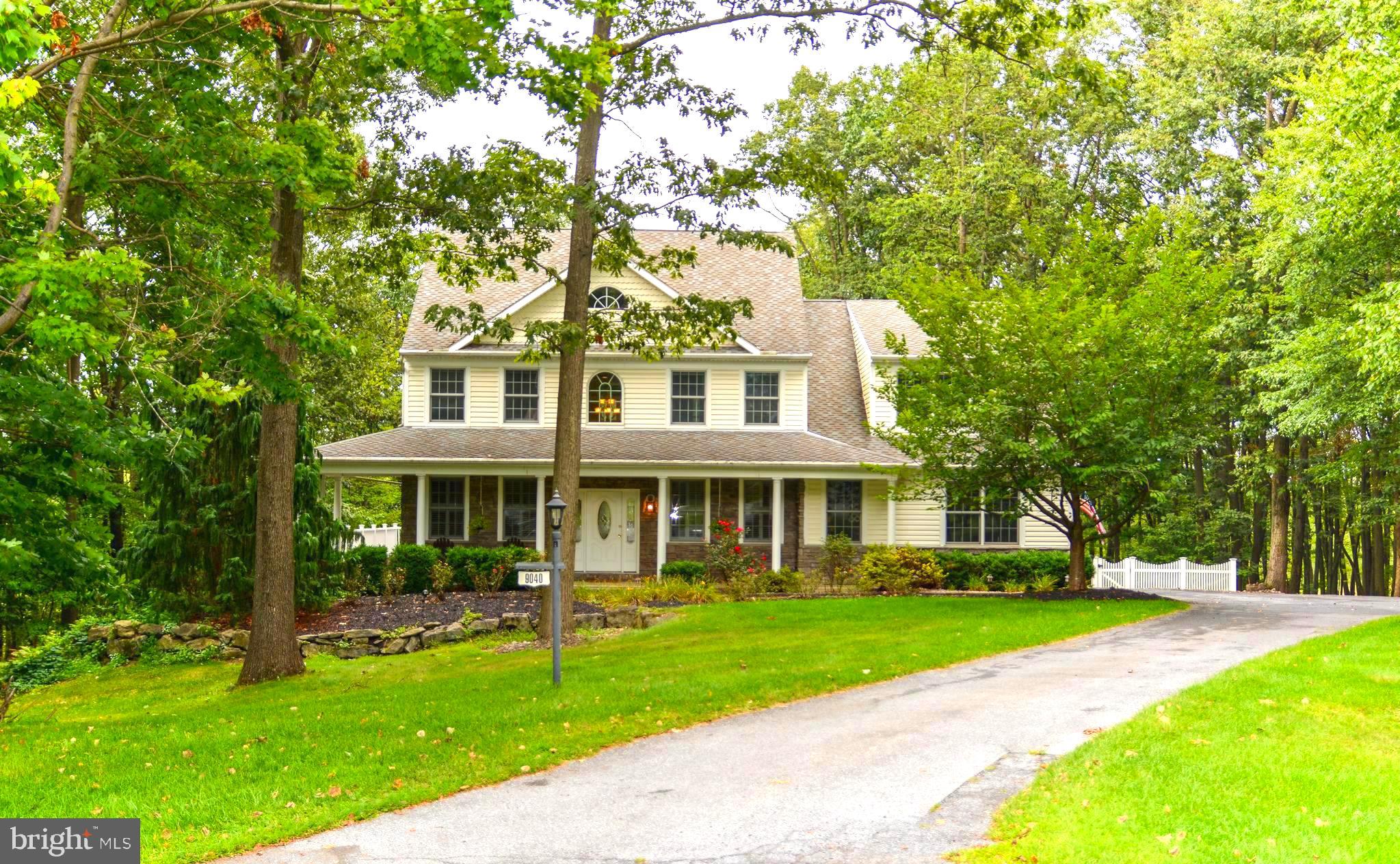 Nestled on 3.9 private, wooded acres at the end of a quiet cul-de-sac, this stunning 3-bedroom, 2 full & 2 half-bath Colonial blends timeless charm with modern amenities. The main level welcomes you with open-concept 9-foot ceilings that create a bright and spacious feel with redwood hardwood floors throughout. The eat-in kitchen, featuring hickory cabinets, flows seamlessly into the impressive great room where a floor-to-ceiling stone fireplace serves as the centerpiece. Off the kitchen, a large mudroom with custom cubbies offers a side entrance & provides both storage and functionality, with direct access to the oversized 3-car garage. A breathtaking staircase leads to the upper level, where the primary suite offers a peaceful retreat with a cozy sitting area. The spa-like bath features heated tile floors, a jacuzzi tub, a walk-in shower, and abundant closet space. The finished lower level is designed for entertaining, complete with 9-foot ceilings, a custom bar, a half bath with urinal, and an additional den/bedroom—ideal for overnight guests. A walkout leads to a stamped concrete patio, perfect for gatherings and outdoor fun. Outdoor living truly shines here with a custom-built fireplace, hot tub, and a spacious wraparound Trex deck overlooking the private, wooded backyard—ideal for hosting or simply unwinding in nature. With incredible curb appeal and a peaceful cul-de-sac setting, this home offers comfort, style, and endless opportunities to relax or entertain. Welcome Home