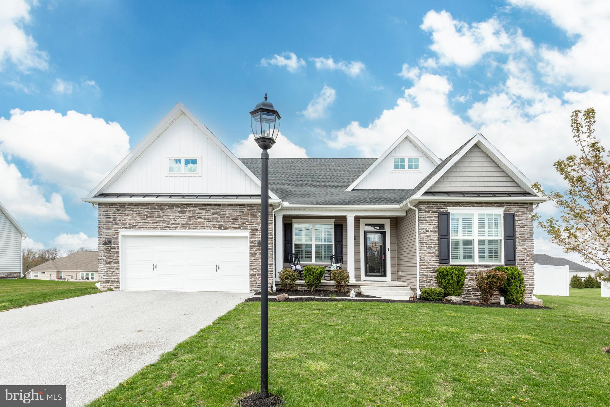 Open House: Saturday, April 19th 10-12noon. Better Than New! This stunning stone-front farmhouse-style rancher offers charm, comfort, and thoughtful upgrades throughout. A welcoming front porch leads into an open-concept layout with luxury vinyl plank flooring and plantation shutters. The private home office with built-ins is perfect for remote work. Enjoy a show-stopping kitchen with tons of white cabinetry, a large island, pantry, and shiplap-accented dining room. The spacious family room features a tray ceiling and opens to a beautifully hardscaped patio with a fireplace and built-in seating—ideal for entertaining. Fenced in yard and a storage shed complete the backyard living space. The split-bedroom design provides privacy, with two guest rooms and a full bath on one side, and a luxurious owner’s suite on the other, complete with tray ceiling, walk-in closet, and spa-like bath. Downstairs, the unfinished basement includes a full bath rough-in, tons of storage, and walk-up access. Truly better than new—move-in ready and waiting to welcome you home!