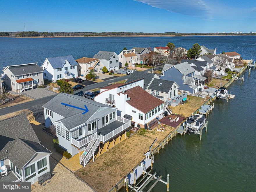 This fabulous waterfront home has it all, including fantastic views down the canal to the open water of the St Martin river just a minute away, and views overlooking the beautiful Ocean Pines Swim & Racquet Club (a wonderful waterfront park).  This home was updated by the current owners in 2022, and updates include: gorgeous new open living space on the upper level overlooking the water, with beautiful gourmet kitchen; new large composite deck and railings; new flooring throughout the home; most new windows, new interior paint. This upper level also includes 3 bedrooms, 2 bathrooms and a sun porch.  The lower level helps to spread out the great living space of this home - with a waterfront bedroom,  a large waterfront family room (which could be used as a 5th bedroom), a 3rd full bathroom, a large utility room perfect for all your beach toys, and a garage with workbench and cabinets.  Additional features of this property include a dock, an electric boat lift, a manual lift for smaller boats, an  outdoor shower with new hardware,  and an attached shed with work bench.  (Note: The current owners have never used the boat lifts, so the condition is not known and maintenance may be needed.) Take a two minute walk to the Swim & Racquet Club, with the wonderful riverfront pool, the kiddy splash area, tennis courts, beach area, marina with boat slips & pavilion area for fishing & crabbing. Hop on your boat and head out to explore all the great open waters, including the St Martin River, the Isle of Wight Bay, Assawoman Bay, and the back bays of Assateague Island.  This is the beach life at its finest, in the wonderful Ocean Pines community with low fees and great amenities! This low maintenance home is being sold furnished as seen.