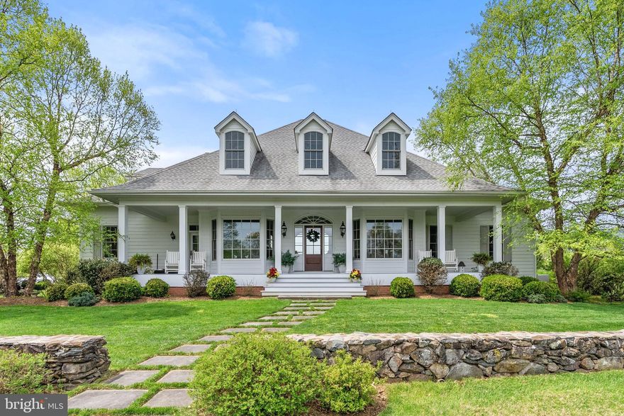 A quiet and picturesque country lane in the heart of Virginia’s renowned “Hunt Country” leads to “Foxwood”, an absolutely beautiful estate in a storybook setting. Impressive stone pillars mark the entrance to this spectacular property and a long winding tree lined drive leads to the stunning custom residence of extraordinary quality and craftsmanship. Ideally located just minutes north of the charming village of Middleburg, Foxwood encompasses over 35 acres of lush fields, brilliant gardens, and majestic oak trees. A 20+acre fenced paddock with a huge run-in shed and automatic waterer can easily be converted to a small stable and create a perfect haven for treasured equines. A fabulous 34 acre parcel, adjacent to Foxwood, could also be available. Breathtaking views of the magnificent Blue Ridge Mountains serve as a backdrop to this superbly built manor of uncompromising quality and exceptional beauty. Timeless elegance meets modern sophistication, boasting over 5,000 square feet of meticulously designed living space. In addition, there is over 3,100 square feet of partially finished space all set to be completed. This estate is a true sanctuary of privacy, charm and refined luxury. Step inside and be greeted by soaring ceilings, custom millwork, and sun-drenched interiors that instill a sense of effortless grandeur. Multiple oversized windows and glass paned French doors create a bright and airy atmosphere, capturing panoramic views from every corner of the home. An extraordinary 13-foot-high Palladian window in the rear façade illuminates the huge rooms with natural light and presents stunning views of the idyllic setting. A grand center hall welcomes guests and visitors which opens to an elegant, banquet sized dining room, enhanced by an exquisite crystal chandelier. The formal living room/office enjoys a three-bay picture window overlooking the pond and nature in all its boundless beauty. The gourmet country kitchen is a chef’s dream—outfitted with top-of-the-line appliances, customized cabinetry and a statement island perfect for gathering of family and friends. Flowing seamlessly into the “great room” and informal dining area, this home was designed for both intimate dinners and grand celebrations of the holidays. Retreat to the primary suite, a private haven featuring a spa-inspired bath, large walk-in closets and a handsome private office, all including serene views of the beautifully landscaped grounds. A brick walled gas fireplace warms the suite on chilly evenings and creates an incredible ambiance of peace and relaxation. Three additional spacious bedrooms on the second level offer flexibility for wonderful guest suites, home offices, or fitness rooms. Outdoors, from the beautiful decks, enjoy tranquil mornings watching the glorious sun rise and in the elegant evenings, experience the exquisite sunsets. Located in one of the finest areas of Northern Virginia, Foxwood offers proximity to excellent schools, vibrant downtown shops and dining, with easy access to the Nation’s Capital. Foxwood is an exceptionally beautiful country estate, in pristine condition, providing charm and elegance for a gracious and luxurious lifestyle. •Property is in Land Use and protected by a Perpetual Easement. •Magnificent Blue Ridge Mountain views •Huge run-in shed enclosed in a 20+ acre fenced paddock with automatic waterer •Over 5,000 sf •Additional 3,100 partially finished sf, all set for completion on the walk-up level •Hardie Board siding •Premium Architectural shingles (7 years old) •Fireplaces: one brick woodburning (Great Room) and one brick wall gas burning (Primary Suite) •Antique vintage brick throughout the house and Hardwood Floors •Outdoor Pistol Range. Regulation size Croquet Court •Whole House Generac Generator 48KW •Grundos Whole House water pressure system •Tankless propane hot water heater •Sophisticated HVAC System •Whole House Fire/Security system