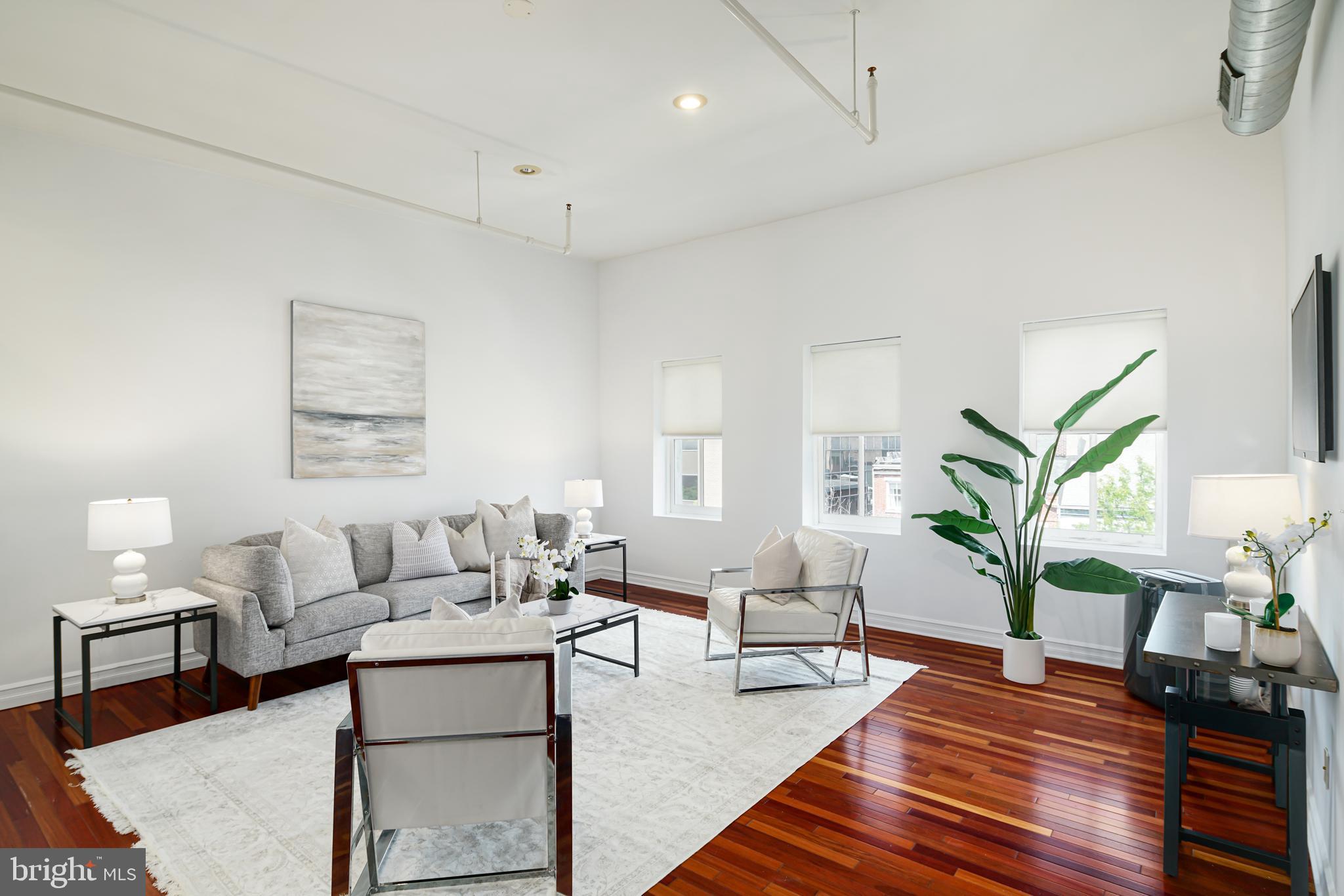 Welcome to 312 Market St, a spectacular 2 bedroom, 2 bathroom condo in the heart of Old City. Enter into a contemporary living space drenched in natural light with soaring ceilings, industrial-chic exposed ductwork, neutral walls, gorgeous wood floors, recessed lighting, and ample windows looking out on the Ben Franklin Bridge. Here you will also find the first bedroom kept bright via skylight and transom with built-in shelving. Moving down the hall, pass your laundry room with ample shelving and storage and into your modern kitchen. With ample space for a small table and plenty of room in the built-in bar, entertaining will be effortless as guests enjoy the natural light provided by twin skylights while you enjoy your white shaker cabinets, upgraded countertops, stainless steel appliance package including gas stove and brushed steel accents. Don't worry about storage as the area is equipped with ample closet space for a pantry and more. Move down the hall past the first full hallway bath complete with elegant slate stall shower and into your luxurious primary suite. Equipped with sophisticated sliding glass closet and contemporary en-suite with modern stainless steel hardware, marble flooring, and soaking tub, this space is sure to become your city paradise complete with gorgeous skyline views. This condo is situated in the middle of all that Old City has to offer and is located right next to the Ben Franklin Museum, an incredible amount of eateries, bars, shopping and public transportation - a block away from 5th St & 2nd St metro and a bus stop on the corner. Be sure to see this one today! Parking is usually available at Auto Park at Old City lot for $245 a month. Photos are from a previous listing. Rent is negotiable with a two year lease