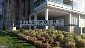 This 2 BR, 2.5 BA unit is in the desirable Skytown on the 10th fl of Silo Point! The 2238 sq.ft. home is one of the largest units with tons of storage. House includes granite counters, ss appl, wood fls, LGE bedrooms, & a LGE den. Enjoy water views from the 3rd fl master suite. LGE 1st Fl Patio & 3rd Fl Balcony. 2 Parking Spots. 24 HR Desk w/ Concierge. Top of the Line Gym. Game Room. Conf Rooms.