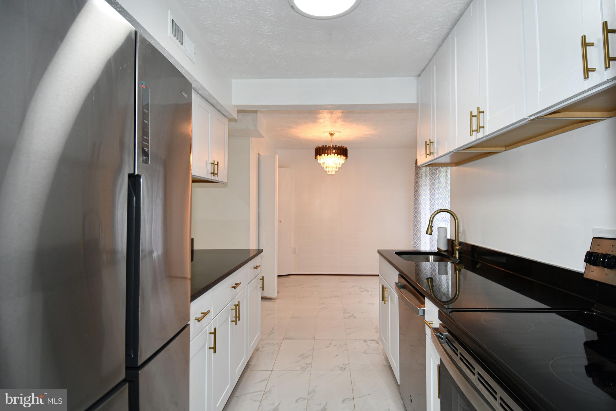 Welcome to the sought after Greenbriar Condominium Community located directly across the street from highly desired Eleanor Roosevelt (Science & Technology) High School. As you enter this home, step down into the living room which is offset by a bump out area that can be used as a reading, plant or open office space. The dining area along with the washer and dryer set (2024) are conveniently located off of the kitchen. Your bedroom includes not one but two closets! As an added bonus, there is a unique space with an optional door that be used as guest space/den or exercise room. The condo fee includes electric, water & sewer, trash, access to the swimming pool, tennis and newly added pickle ball courts. There is also an event space that can be rented. Location is everything! Walk across the parking lot and catch the bus to the Greenbelt Metro Station, University of Maryland, grocery store, pharmacies, restaurants, lab centers, PM Pediatric Urgent Care or Doctor’s Community Hospital. Don’t walk, run as these condos are rarely available for purchase; FHA, Conventional, VA or Cash.