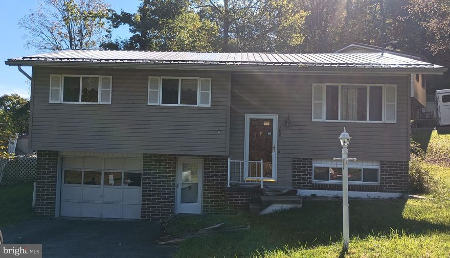 Laminate floors through out.  Eat-in Kitchen,  living Room, finished lower level for game room or family room. Attached garage.  Back porch.  Adjacent parcel available to purchase.