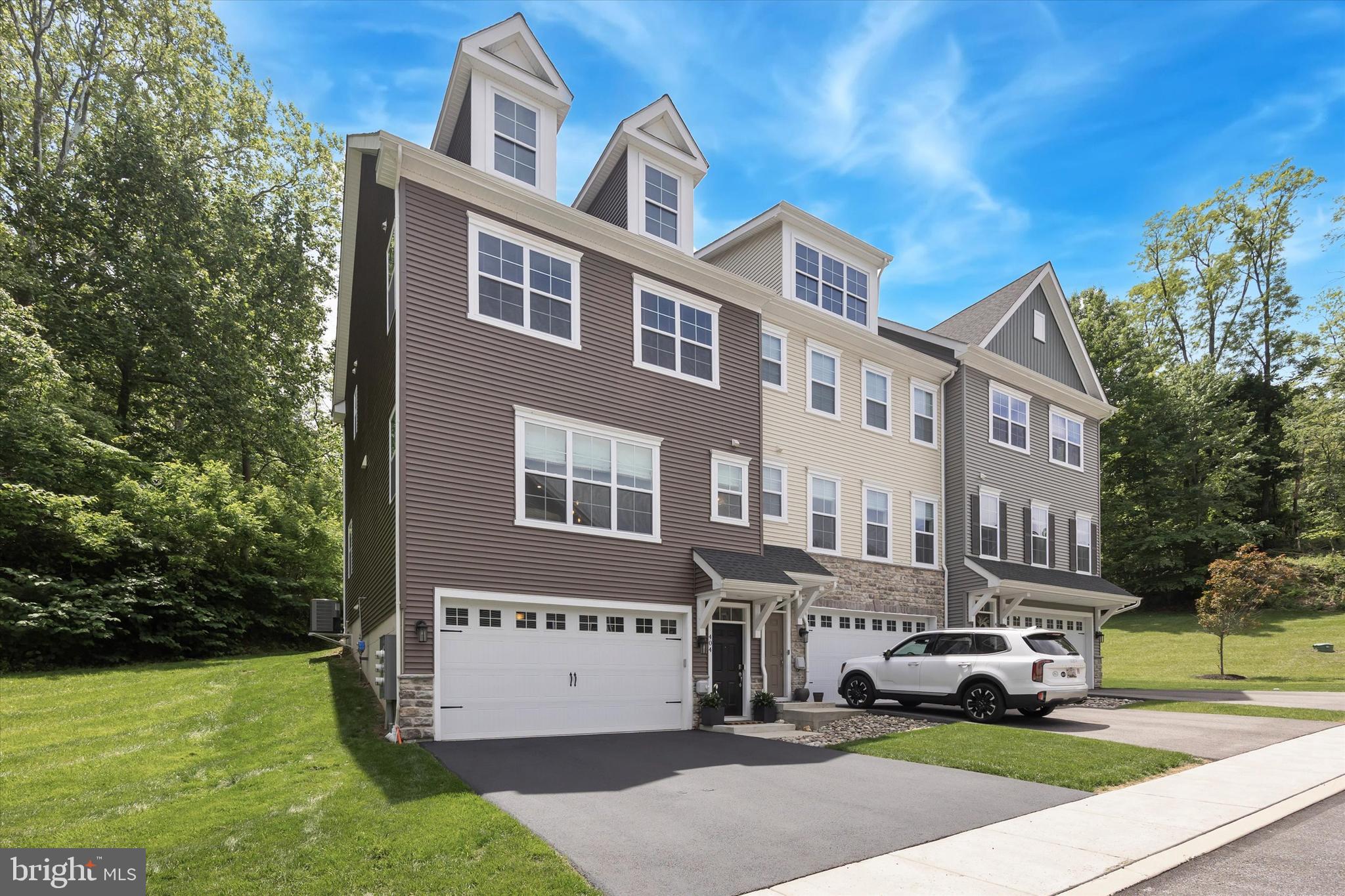 ** 2.99% VA Assumable Mortgage Available (Buyer must be eligible for a VA home loan and qualify with Veterans United Home Loans)** Welcome to 404 Rock Run Circle — where modern comfort meets timeless tranquility.
Tucked away in the coveted enclave of "The Grove at Broomall", this exceptional end-unit townhome is more than just a home, it’s a retreat, a lifestyle, and a rare opportunity to experience peace and privacy without ever being far from life’s daily conveniences. Custom-built in 2021 by its original owners, this premium model was carefully selected for its expanded width and additional square footage, offering an open, airy feel throughout all three levels.
Imagine this: you’re driving home, turning off a tree-lined road, crossing a gentle bridge, and entering a beautifully maintained community where manicured lawns, lush landscaping, and a sense of calm greet you at the gate. Despite being just minutes from grocery stores, fitness centers, restaurants, and major highways with direct access to Center City and the Main Line, it feels like you’re entering your own secluded haven.
As you arrive at 404 Rock Run Circle, you’ll notice the recently seal-coated two-car driveway and oversized garage spotless and spacious ideal for both storage and daily use. Step inside, and the lower level welcomes you with a versatile finished space, perfect for a home office, playroom, gym, or media lounge. A convenient half bath makes this level as functional as it is flexible.
Head upstairs, and natural light pours in from oversized end-unit windows and double French doors, highlighting the expansive open floor plan. The living room, dining area, and kitchen seamlessly flow together, creating a space that’s perfect for hosting or simply relaxing with family. The kitchen is outfitted with sleek stainless steel appliances, two generous pantries, modern finishes, and ample counter space — a true culinary haven. Step outside onto your private rear deck and exhale: your view is nothing but serene woods, birdsong, and sunlight. With a privacy divider and no neighbors in sight, this is where your evenings unwind glass of wine in hand, stars overhead.
Upstairs, the third level offers thoughtful convenience and exceptional comfort. A discreetly built-in automatic blind system conceals your upper-level laundry area, while two spacious guest bedrooms share a bright, updated full bathroom. But it’s the primary suite that truly defines luxury. With soaring ceilings, recessed lighting, and the same treetop view, this space is a calming retreat from the everyday. A generous walk-in closet and spa-like ensuite bathroom with modern appointments complete the suite.
Additional features include: smart home capabilities, an integrated security system, energy-efficient HVAC, newly installed Anderson French Doors, high quality steel shelving in the garage, and all the conveniences today’s buyers demand but rarely find in such a natural setting.
404 Rock Run Circle stands out not only as one of the finest homes in Broomall, but as a rare blend of high-end living and peaceful seclusion. Whether you're entertaining on the deck, working from your sunlit home office, or simply enjoying the comforts of new construction, this home delivers the lifestyle you’ve been searching for.
Don’t miss your chance to experience the best of Broomall serenity, style, and sophistication, all in one.