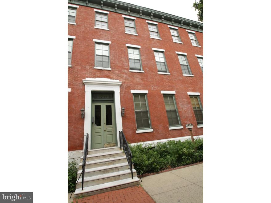 Parking, basement storage and 2 roof decks!! This 1 Bed/1Bath condo is located on the first floor and includes a DEEDED PARKING SPACE (parking area is gated). Hardwood floors run throughout the unit and are complimented by a fireplace and 12 foot high ceilings in the living/dining room. Natural light abounds in the living/dining room favoring the neutrally painted interior. An exquisite pocket door separates the living/dining area from the kitchen. The tiled bathroom houses a Whirlpool/Jacuzzi tub. For the entertainer or griller, there are two communal Roof Decks and a shared Brick Courtyard. A storage area is located in the full basement. This gem is within walking distance to the Museums, Boathouse Row & River Drive, Whole Foods Market and various restaurants