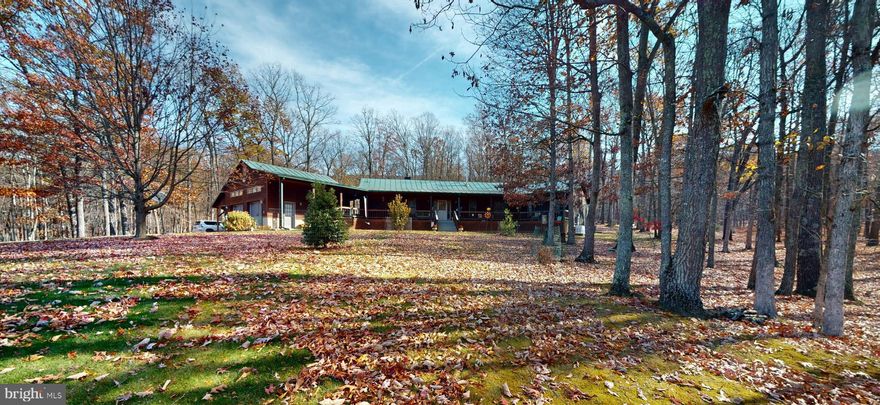 This utterly unique, custom-built, cedar-sided home is the epitome of rustic and modern elegance.  The home is situated on  25 ACRES with a large SPRNG FED POND.   The property has been immaculately kept and is truly exquisite. Your turnkey home in beautiful WV awaits!  Host family and friends in the open, modern kitchen.  With updated appliances including a gas stove, large walk-in PANTRY, large island with a second sink and solid surface counters, it truly is a culinary delight. The living room is expansive, with an stacked-stone, wood burning fireplace, an abundance of natural light and  vaulted ceilings, creating a warm and inviting ambiance.  In addition, the home dons TWO PRIMARY bedrooms each with walk-in closets and en suite bathrooms and walk-in showers.   WOW & the third bedroom has an attached Jack n Jill Bathroom.  Perfect for guests – rentals are permitted. The bonus room has variable potential as an office, gym or additional guest space. Red Oak Hardwood flooring, Ceramic Tile & Vaulted Ceilings throughout the home. Relax  on your covered front porch connecting to the 2 car climate controlled Garage and 2 car Carport.  Plenty of Covered parking! This space practically begs you to unwind in the rocking chairs.  An adorable matching shed and a meticulously fenced-in garden areas, pergola and large back deck complete the exterior.  An additional water feature can be found on the West boundary where WATERLICK Run flows and is within hearing distance of the house.  The acreage is 100% usable with towering HARDWOODS, HUCKLEBERRIES, MOSSY CARPET, MOUNTAIN VIEWS, PASTURE & TILLABLE LAND.   Flowering & Fruit Trees can be found here.  Check out a few of recent updates: whole house generator, all new heating and cooling systems, tankless propane water heater, whole house stained & decks refinished. Come see 315 Beech Lane, its not just a house but a home. This home is a true masterpiece, waiting for its new owners to fall in love with it.