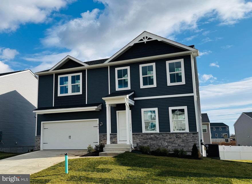 February Move-In at Liberty Run! Fall in love with the Water Lily—a thoughtfully designed home that blends style, space, and smart living in one stunning package. Located just over the Jefferson County line in Berkeley County, Liberty Run offers the ideal location for NOVA/DC commuters seeking peace, convenience, and value. This 5-bedroom, 3-bath home is packed with upgrades and charm, starting with an open-concept main level featuring soaring 9' ceilings, recessed lighting, and wide plank laminate flooring. The kitchen is a true showpiece—quartz countertops, a large center island, white enamel farmhouse sink, ceramic tile backsplash, and upgraded dark-stain farmhouse-style cabinetry. Top it off with upgraded stainless-steel appliances and a double pantry for the perfect blend of function and flair. A main-level bedroom with full bath offers flexible living options, while the home office creates the perfect remote work setup. Upstairs, you'll find 4 spacious bedrooms, a full laundry room with GE Washer/Dryer, second family room/loft, and a show-stopping primary suite with dual oversized walk-in closets and a spa-style bath with a frameless walk-in shower and double vanity. Need more space? The unfinished basement with L-shaped areaway provides endless potential for future expansion or storage. that includes a rough in for a full bath. This home also includes a stunning stone water table, designer chandelier, and today’s most sought-after tech upgrades: • Wi-Fi garage door opener • Ring video doorbell • Kwikset HALO Wi-Fi smart lock • Upgraded CAT6 + RG6 wiring throughout and more! Come see why Liberty Run is one of the area’s fastest-growing communities. Schedule your tour of the beautifully decorated *Water Lily* model today and ask about our limited-time buyer incentives! *Photos are of a similar Water Lily model. Taxes are an estimate.*