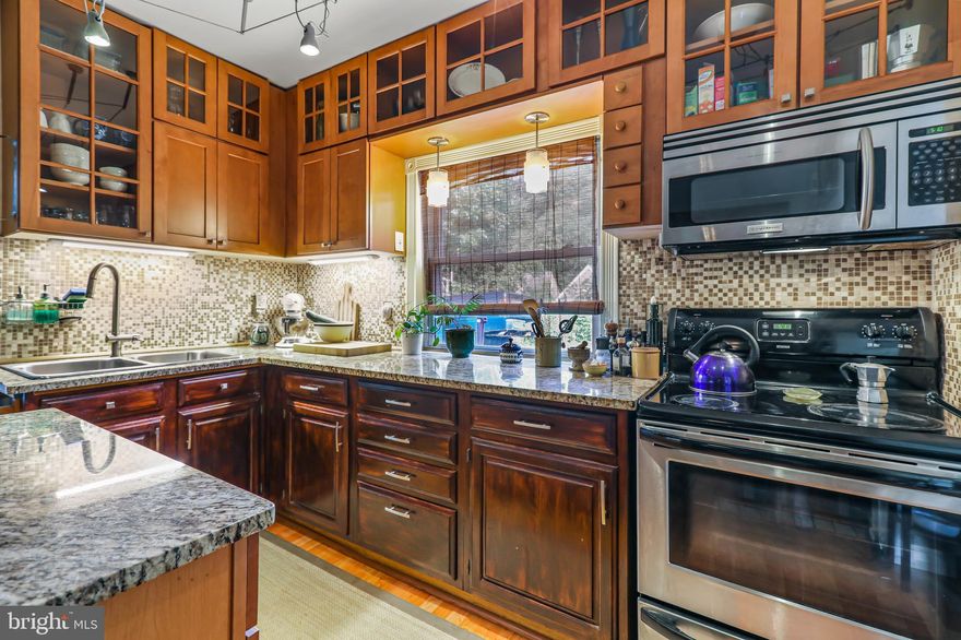 Beautiful and tasteful finishes are everywhere you look in this fully renovated home! The kitchen has new cabinets, tile backsplash, granite countertops, stainles steel appliances, and a large island. The main floor has been made quite open by removing walls and widening doorways. There is a wood burning fireplace in the living room with built-ins on both sides. The fireplace itself has been attractively refaced. The enclosed front porch is heated for four season comfort. What a great place for an office or sitting area -- you are in the tree tops! The hardwood floors on the second level have been refinished and have stenciled borders for that added bit of charm. The entire house has been freshly painted both inside and out. And to "top" it all off, a new roof was just installedin June.