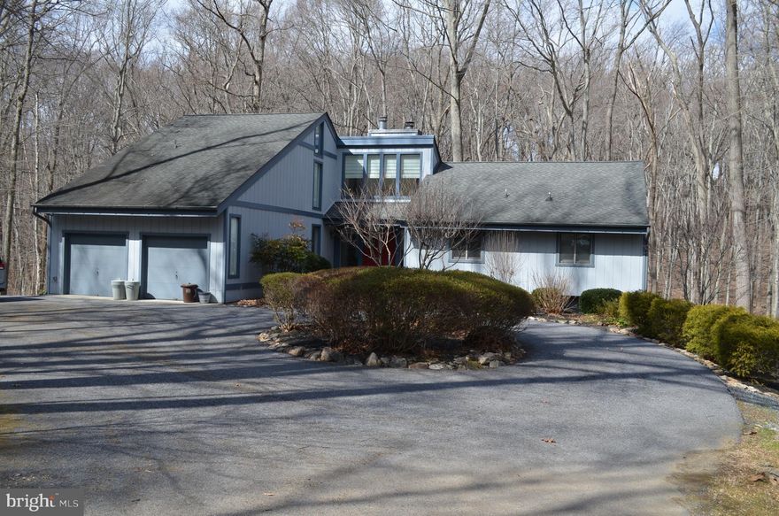 Beautifully updated Colonial with a Contemporary flair boasting a total of 6 bedrooms and 4 full baths in highly sought-after Holly Knoll Estates. Center cul-de-sac location backing to woods and stream offering unmatched privacy in a serene setting.  The kitchen features custom cabinets, granite counters, SS appliances and breakfast area. Dining room with built-in sideboard and wine rack. Great room with soaring ceilings, wood-burning fireplace overlooking woods. Owner's suite in upper level with private bath and walk-in closet. Possible bonus room on this level as well.  Finished lower level features family room with gas fireplace, 2 BR's, full bath, storage area and large workshop with walkout to rear yard.  Additional features include hardwood flooring, energy-efficient Geo-Thermal heating/cooling system, 25 kW house generator. Huge rear deck perfect for entertaining and relaxing. Three additional decks. Close to all amenities and the timeless beauty of the Loch Raven Watershed Area.  See it before it's gone!