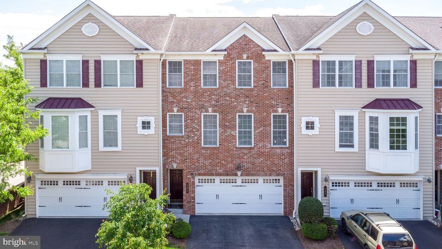 Welcome to 103 Mary Ambler Way. This stunning, brick front,
meticulously maintained 3-bedroom, 2.2 bath townhouse is nestled in
Station Square Ambler Boro, walking distance to train and the quaint downtown area with shopping, coffee shops, restaurants, and seasonal festivals. Easy access to the major highways and PA turnpike, the home offers an open-concept floor plan filled with natural sunlight, high ceilings, and a spacious living room and dining room area with beautiful premium inlaid wood flooring, built-in speaker system, recessed lighting and crown molding throughout, including in the powder room. The center island’s custom gourmet kitchen, complete with overhead pot rack, offers an abundance of wood cabinets, gas cooking, built-in pantry, stainless steel appliances. The cozy breakfast nook is highlighted by a sliding glass door to the private covered deck and the tranquil tree setting, a perfect place to read your favorite book or simply relax three seasons out of the year, even when it is raining. The lower level features a generous-sized family room and powder room with a new radiant heat tile floor that extends into the walk-in closet with upgraded, built-in storage, sliding glass door walk out the to the back yard as well as access to your 2-car garage with additional overhead lighting and a bonus, stainless steel utility sink.  The 2nd level features new hardwood floors in the hallway and all three bedrooms.  The primary bedroom room is accented with a feature wall, gleaming wood floors, a huge walk-in closet and a beautiful ensuite bathroom that includes a shower with glass doors and a dual vanity. The two bright and airy additional bedrooms include ample closet space and recessed lighting. This level also hosts a hall bathroom with tub and shower and a laundry room with additional closet system shelving.  Sought after Wissahickon School District. This unit was one of the original models and is a wonderfully warm and inviting place to call home.