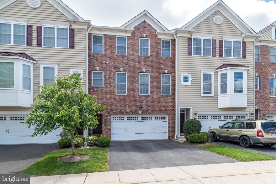 Location Location! Welcome to 103 Mary Ambler Way. This stunning, brick front,
meticulously maintained 3-bedroom, 2.2 bath townhouse is nestled in
Station Square Ambler Boro, walking distance to train and the quaint downtown area with shopping, coffee shops, restaurants, and seasonal festivals. Easy access to the major highways and PA turnpike, the home offers an open-concept floor plan filled with natural sunlight, high ceilings, and a spacious living room and dining room area with beautiful premium inlaid wood flooring, built-in speaker system, recessed lighting and crown molding throughout, including in the powder room. The center island’s custom gourmet kitchen, complete with overhead pot rack, offers an abundance of wood cabinets, gas cooking, built-in pantry, stainless steel appliances. The cozy breakfast nook is highlighted by a sliding glass door to the private covered deck and the tranquil tree setting, a perfect place to read your favorite book or simply relax three seasons out of the year, even when it is raining. The lower level features a generous-sized family room and powder room with a new radiant heat tile floor that extends into the walk-in closet with upgraded, built-in storage, sliding glass door walk out the to the back yard as well as access to your 2-car garage with additional overhead lighting and a bonus, stainless steel utility sink.  The 2nd level features new hardwood floors in the hallway and all three bedrooms.  The primary bedroom room is accented with a feature wall, gleaming wood floors, a huge walk-in closet and a beautiful ensuite bathroom that includes a shower with glass doors and a dual vanity. The two bright and airy additional bedrooms include ample closet space and recessed lighting. This level also hosts a hall bathroom with tub and shower and a laundry room with additional closet system shelving.  Sought after Wissahickon School District. This unit was one of the original models and is a wonderfully warm and inviting place to call home.