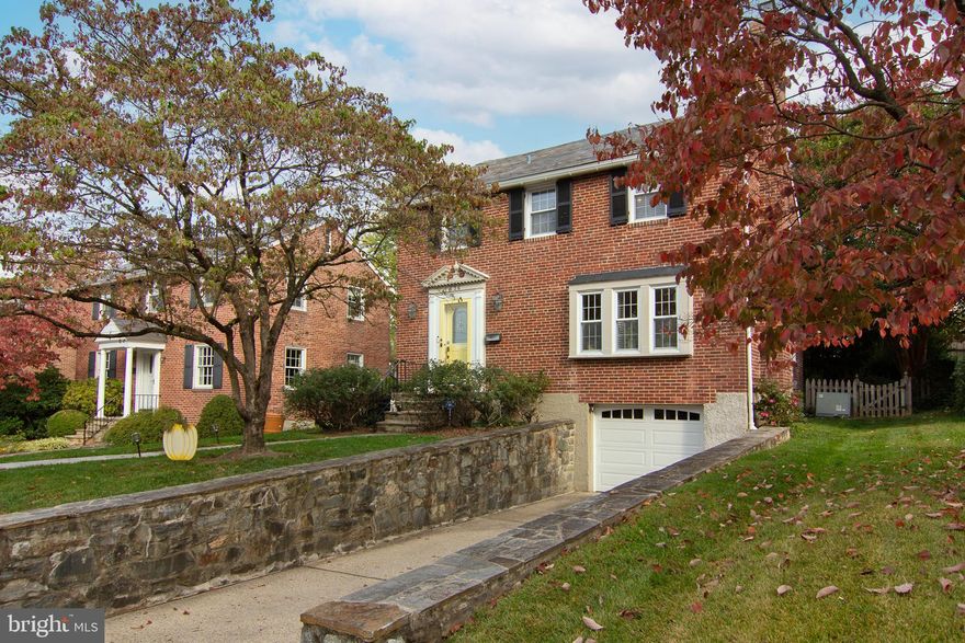 Discover the charm and elegance of this beautiful three-bedroom Colonial home nestled on a picturesque, tree-lined street in the highly sought-after neighborhood of Anneslie. Meander down the stone walkway and feel like you are home from the moment you walk in the front door into a warm and inviting foyer, featuring lovely hardwood floors, crown molding, and a modern color palette that welcomes you as you venture from room to room. The living room is rich with natural light, with a brick-surround  wood mantled wood-burning fireplace which extends a cozy welcome to all. Continuing on, the dining room awaits your next festive occasion, with classic box wainscoting and a statement chandelier that adds a touch of sophistication. The gourmet eat-in kitchen is a delight for both preparing and sharing meals, featuring crisp white, soft-close cabinetry with display upper units, stainless steel appliances, including a gas range with convection capabilities, and a peninsula island with seating and storage. Seamlessly flowing from the gourmet kitchen is the step-down family room, offering stunning views of the fenced rear lawn with mature trees and a stone patio, perfect for your own serenity garden. A convenient powder room completes this amazing main level. Stepping up to the 1st  upper level, you'll find three spacious bedrooms and a shared hall bath, elegantly designed with classically beautiful black and white hex honeycomb mosaic tile flooring and a ceramic tile surround tub shower. The large  second upper-level bonus room offers versatility as an office, possible bedroom, or studio, providing the ultimate in privacy. The lower level presents incredible flexibility as a recreation room, second office, or whatever fits your needs. Here, you'll also find a second powder room, laundry facilities, a utility room, and access to the garage with a new garage door for added convenience. This area has much to offer, from the  parks like Cylburn Arboretum, Lake Roland Park, and Sherwood Gardens to the multitude of shopping and dining options, including the local favorite Belvedere Square Market. Major commuter routes such as I-83, Charles Street, and York Road, plus the nearby Light Rail, make commuting a breeze. Welcome Home !