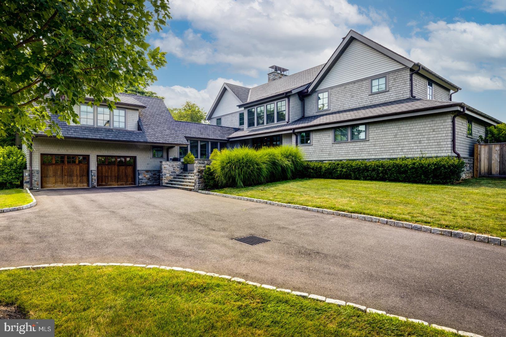 A rare opportunity to live on private grounds, abutting the Philadelphia Cricket Club's Saint Martin's golf course, with a TAX ABATEMENT UNTIL 10/28, on one of the most coveted streets in Chestnut Hill. This home is a true blend of traditional and contemporary spaces with exquisite finishes throughout. The modern Kitchen includes Poggenpohl cabinetry, marble backsplash and countertops, Wolf range and microwave drawer, Bosch dishwasher and SubZero refrigerator. Light-filled and open 2 story living room with a wall of windows and built-in cabinetry, Kingsman two-sided fireplace and wet bar. The main floor Primary bedroom en suite offers a bathroom with large marble steam shower, hydrosystem tub, radiant heated floor and double vanities. Also included is a customized California closet, gas fireplace and French doors leading to a beautiful covered porch. The second floor offers two additional bedrooms en suite that could also be incredible home/school offices. The Lower Level is completely finished with oak wood flooring, recreation area, kitchenette with Poggenpohl cabinets, marble countertops, SubZero refrigerator drawers and ice maker. There is a wine cellar with Millesmine racks and tech lighting. Also find a large gym with full marble bathroom and a large movie theater with screen, projector and World Wide Stereo equipment included. Three large storage closets finish this lower level. A fourth bedroom en suite is located over the garage and adds to this amazing property. Additionally, a Hunter Douglas automated blind system has been added throughout the home. City of Philadelphia Tax Abatement in place until 10/2028. This home is conveniently located to the City of Philadelphia, New York City, Philadelphia International Airport and Train systems. Schedule your private showing today.