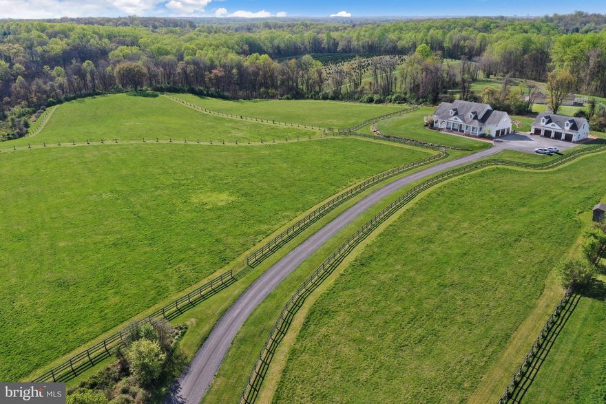William E. Poole Designs NC. Architect. This stunning 36-acre estate is perfect for outdoor enthusiasts and privacy seekers. It’s only minutes away from access to all that DC/MD/VA has to offer. This estate features everything you need for the perfect equine experience or Ag vision, including 8 large pastures, a 6-stall barn, circular riding pen, two run-in sheds, and miles of riding trails. The custom built home was completed in 2010 and utilized the finest building materials available. The house is highly efficient and includes home automation. The main house greets you with an enticing front porch, a perfect spot to sit and admire this gorgeous property. When you enter the house, you will find yourself in a grand foyer flanked by the formal dining room to your right and an oversized study with gas fireplace to your left. Straight ahead you will find yourself in the two story great room with a cozy gas or log fireplace. Just off the great room is the eat-in Chef's Kitchen with a 48 inch AGA commercial range. The primary bedroom is conveniently located on the main level with a massive custom built walk-in closet and Spa-like primary bathroom complete with soaking/jet tub, separate shower, and double vanities. Please take note of the custom hardwood Hickory wide plank floors and top of line Andersen Windows. The second level boasts 4 oversized bedrooms and nicely appointed hall bath with double vanities and a classic laundry chute. There is a bonus lounge area overlooking the great room with a full bath rough in. The lower level of the home features a partially finished hobby room/workshop. This level offers the opportunity for more square footage and features a walk out and another full bath rough in. Completing the main home is another beautiful rear porch and 3 car side load garage with high ceilings. The Carriage House has 4 oversized garage bays with an EV charging station and two hoist lifts. Above the garage is a beautifully appointed apartment with a full kitchen, bedroom, bath, and living room. This could be the ideal space for a Farm Manager, Airbnb, Mother-in-law or additional rental income. The Germantown location of this estate is very rare. In less than 10 minutes, you could be shopping at Wegman's or Home Depot or dining at numerous restaurants. Quick access to 270 and all points North and South. Additional exterior features are irrigation and drip systems, electric fencing and stone retaining walls. This property is a must see!

--