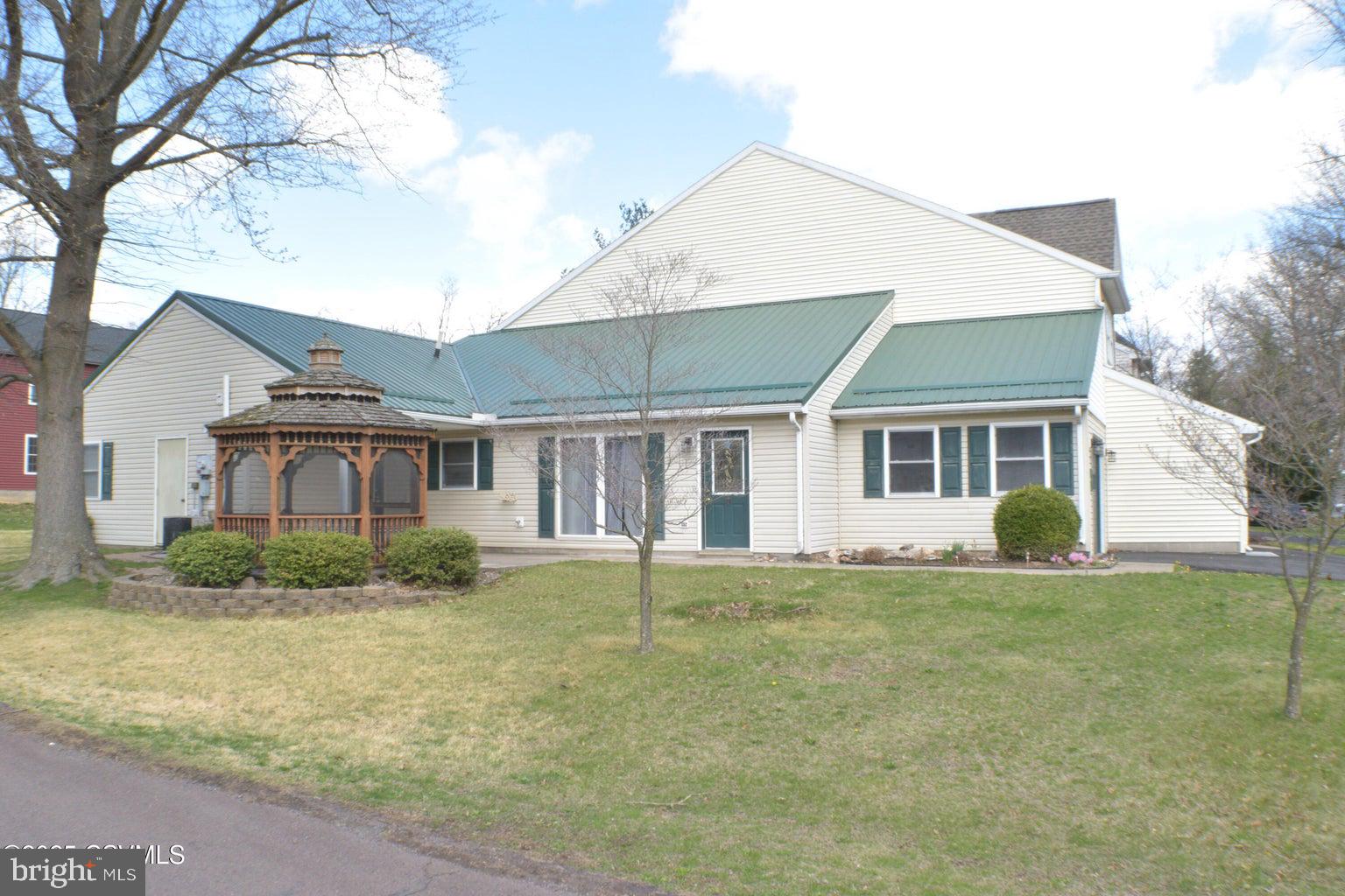 Corner lot - two-bedroom ranch townhouse. Carefree living on one level, corner lot, side yard with gazebo, attached one-car garage, conveniently located to everything. Metal roof and updated tile shower. This style of townhouse does not come along often.