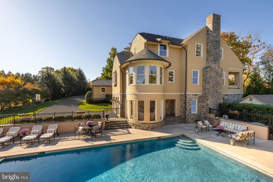 Nestled amidst towering trees and rolling lawns, The Owl’s Nest is a historically significant estate in Forest Hills that embodies the perfect union of classic elegance and modern design. Originally crafted by celebrated Washington architect Appleton P. Clark in the late 19th century, this landmark home has been meticulously restored, expanded, and modernized under the visionary architect George Myers, and the renowned Gibson Builders. Every detail has been thoughtfully reimagined, preserving its historical integrity while meeting the demands of contemporary luxury living.

The estate’s striking exterior, clad in oversized local stone and accentuated by thick mortar, showcases the timeless allure of the shingle style. With its elegant curves, distinctive gables, and turret, The Owl’s Nest boasts a commanding curb appeal that is both unique and unforgettable. A deeply recessed entrance framed by a graceful stone archway leads to the grand foyer, where the original wood-paneled staircase has been lovingly restored. A stunning stained-glass window depicting an owl adds a touch of enchantment, glowing softly when backlit at night.

Spanning 10,100 square feet, the home’s expanded footprint doubles its original size to seamlessly blend formal and informal spaces. The original wing celebrates its heritage with meticulously restored millwork, stately fireplaces, and a breathtaking library featuring a barrel-vaulted ceiling, wood paneling, and abundant natural light. The newer wing introduces a relaxed, contemporary ambiance, centered around a state-of-the-art chef’s kitchen equipped with custom inset cabinetry, thick-edge marble countertops, and top-of-the-line SubZero and Wolf appliances. Adjacent gathering spaces, including a semi-circular breakfast nook and a cozy family room with a coffered ceiling, exude warmth and sophistication.

The second level is highlighted by a private primary suite that offers a serene retreat. Features include a covered terrace with sweeping views, a luxurious five-piece marble spa bath, and a spacious dressing room with custom built-ins. Secondary bedrooms are thoughtfully designed with unique architectural details and en-suite marble baths. On the top level, a turret room with mullioned windows provides a versatile space, perfect for a fitness studio or creative retreat.

The lower level invites relaxation with a lounge anchored by a dramatic stone fireplace, leading to two covered outdoor porches. Additional spaces include a recreation room, a private den, ample storage, and a full bath.

Situated on 1.56 elevated acres, the estate’s grounds are as breathtaking as the home itself. Rolling hills shaded by mature trees provide a tranquil backdrop, while the expansive rear patio—complete with a rectangular lap pool and privacy walls—is perfect for al fresco dining and entertaining.

The Owl’s Nest is not only a luxurious residence but also a premier venue for distinguished gatherings. With its historic charm and grand spaces, the estate has previously hosted high-profile guests and their accompanying security, offering an elegant setting for both formal events and intimate soirées. Its secluded location ensures unmatched privacy, while the elevated position and thoughtful design enhance its exceptional security. The grounds are easily surveyed, providing peace of mind to discerning buyers who prioritize exclusivity and safety.

The Owl’s Nest is more than a home; it is a rare and irreplaceable piece of Washington’s history, masterfully redefined for today’s most discerning buyers. Combining historical significance with modern luxury, this estate offers an unparalleled lifestyle in one of the city’s most prestigious neighborhoods.