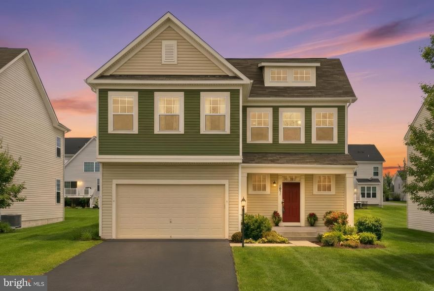 Built in 2017, this beautifully maintained home showcases modern open-concept living with soaring vaulted ceilings and abundant natural light. The gourmet kitchen features stainless steel appliances, ample cabinetry, and a large island that flows effortlessly into the main living areas and outdoor deck - ideal for both everyday living and seamless entertaining.

Enjoy the convenience of a rare main-level primary suite with a spacious bath and two walk-in closets. In addition to four true bedrooms, the home offers two generously sized bonus rooms - perfect for a home office, gym, media room, or guest space. Abundant storage and thoughtfully designed living areas provide both comfort and functionality throughout.

The finished walk-out basement features a spacious rec room with bar, creating the perfect setting for hosting, relaxing, or game nights. A two-car attached garage and rear deck complete the home’s well-rounded design, offering both practicality and outdoor enjoyment.

Perfectly situated just minutes from Routes 28, 234, and I-66, and close to Harris Teeter, Anytime Fitness, Super Target, and a vibrant mix of restaurants and shops. 

Modern design, flexible space, and an unbeatable location. Welcome home! Please note that photos are virtually staged and/or enhanced.