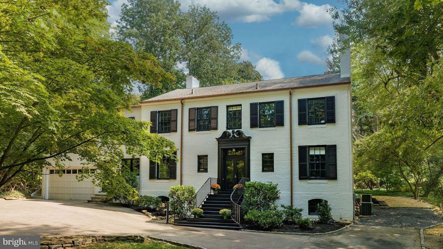 If you are looking for an elegant, classic Chestnut Hill home in a superb, picturesque setting that’s turnkey, then look no further than 22 West Bells Mill Rd. This fabulous home has been meticulously designed by Tallulah & Bird and lovingly restored by RCC in 2023. This home sits on an elevated parklike setting located in the Wissahickon Valley of Chestnut Hill, a short walk to historic downtown Chestnut Hill with superb galleries and culinary venues, along with the Wissahickon Valley trails for biking, walking, and hiking. Upon entering the home, you are greeted by a formal double door entryway that leads to a receiving vestibule to welcome guests. The first floor boasts an oversized living room with a working fireplace. This elegant room is flooded with light from a wall of European styled double French doors that lead to an outdoor patio area. Connected to the living room is the formal yet inviting dining area that also has a working fireplace and a continuation of European French doors that overlook the light filled backyard. If you are a chef or enjoy entertaining, then look no further. The kitchen has been completely renovated to include custom cabinetry, a large, walk-in pantry with custom shelving, commercial exhaust system, custom exhaust vent hood, BlueStar 48” commercial range, 4 Fisher & Paykel Dishwasher drawers, GE Monogram refrigerator/freezer columns, wine refrigerator, unlacquered brass faucets and a 11+’ island with a center dining/seating area that is ready for your family and friends. Additionally, the dedicated wine and coffee bar can be enjoyed from early morning till late evenings. Located off the kitchen is a free-standing solarium/greenhouse that serves as an amazing bonus space for entertainment. This first floor also includes an office/bedroom with built in bookcases and a conveniently located oversized powder room. The federal styled staircase with a ½ landing and window leads to the second-floor with 4 bedrooms and 4 ensuite bathrooms. The primary bedroom being the grandest of all four bedrooms, with vaulted 12’ ceilings, oversized ensuite bathroom with double sink, soaking tub, and separate shower, as well as two fireplaces, are many of the wonderful features of this primary suite. However, the gigantic walk-in closet with custom wall to wall fit outs by California Closets makes this a showstopper. This closet is truly meant for the clothes enthusiast and is complete with a center island for folding clothes, additional storage, and a charming fireplace. The remaining three bedrooms all have newly renovated custom ensuite bathrooms, spacious closest and plenty of windows and sunlight. The hallway includes an oversized laundry closet with front load washer/dryer and folding table. The finished lower level with separate entry delivers additional living space that can hybridize as a second living room, play space, gym or all three. This level also has an additional powder room, separate dry storage room with ample storage for all your extras and two additional refrigerators/freezers. The utility room comes complete with a second set of new high efficiency front load washer and dryer.  HVAC is brand new and features two heating and A/C zones.  This is an excellent opportunity to own a turn key historic home in a fantastic neighborhood.