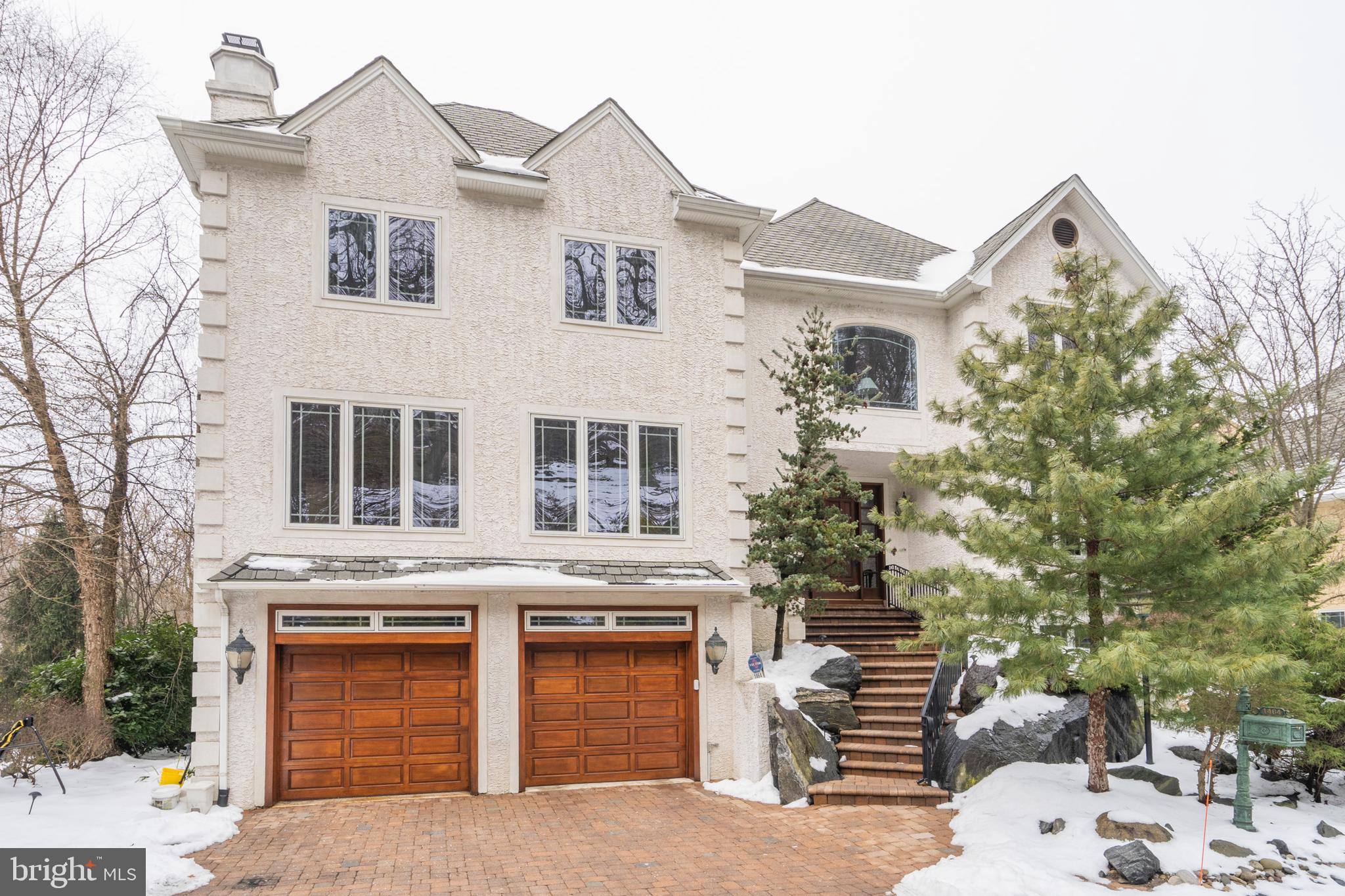 Welcome home to 1464 Wesleys Run. Located in Gladwyne's premier Northwoods Community on a private cul-de-sac, this 6,000+ sq ft. gracious 5 bedroom 4.5 bath custom built home boasts four stories of superior finishes highlighted by an open floor plan, perfect for comfortable living and the very best of entertaining. Every square foot is custom designed from hand-made marble sinks to exquisite stone fireplaces. Modern amenities throughout this entire home with a state-of-the-art family room sure to impress the biggest sports fan! This superb family room with a wet bar and surrounding cherry cabinetry opens up to expose 5 televisions for multi-game viewing and optimal entertaining. Or, you can curl up next to the fire in the amazing lower-level entertainment room/sports bar equipped with 4 televisions, a wet bar, room for a pool table and surround seating for all to gather and watch the big game. Luxurious details are present inside and out including a dazzling 3-story marble reception hall, numerous walls of windows drenching the interior with sunlight, soaring ceilings, wainscoting and crown molding details, six gas fireplaces and a wonderful multi-tiered back deck with gas fire pit, EP Henry terrace, and a koi pond. The fenced yard and turfgrass are perfectly convenient for pet owners. Through the main reception area, you will find the formal living room that flows directly into the elegant formal dining. The chef's kitchen is fully equipped with top-of-the-line appliances, custom cabinetry, a breakfast room with marble flooring, a six-burner cooktop, double oven, AND double microwave perfect for hosting large dinner parties and formal gatherings. There is additional space on the main floor that can be used for a study or main office. Access the second floor via the beautifully spiraled staircase to a large landing area to use as a small den or office and the home's oversized main suite. Perfectly comfortable quarters with heated floors, soaring ceilings, gas fireplace with wall mounted tv, and wine fridge. The marble bath with jacuzzi and glass-surround steam shower is spa-like and even has a tv built into the vanity mirror. The laundry room is conveniently located adjacent to the main suite. There is ample space for any size wardrobe with a large dressing room/closet with tv and a second walk-in closet with an adjoining balcony to look out onto the scenic grounds surrounding this property. There are 2 additional bedrooms on this floor with an elegant marble jack-n-jill bath. The third story is a private suite with a den, bedroom, marble soaking tub, and an attached bath. The lower level has great private space to use as an in-law suite or guest quarters with heated marble flooring bedroom, own private full bath, and walkout deck. Fresh neutral paint and new plush carpeting have just been added. Fully comfortable living with oversized hot water tanks, 4 zoned HVAC system, and alarm system. The two-car heated garage with additional 2 car driveway parking and stone guest parking space. The garage has a convenient dumb waiter for easy transfer of groceries and a cedar closet for extra storage. This truly exceptional home is in an unbeatable location on the Main Line with gorgeous skyline views and is within minutes of award-winning public and private schools, King of Prussia Mall, and major highways serving the surrounding suburbs and Center City. Make your appointment today to see this fantastic home for yourself.