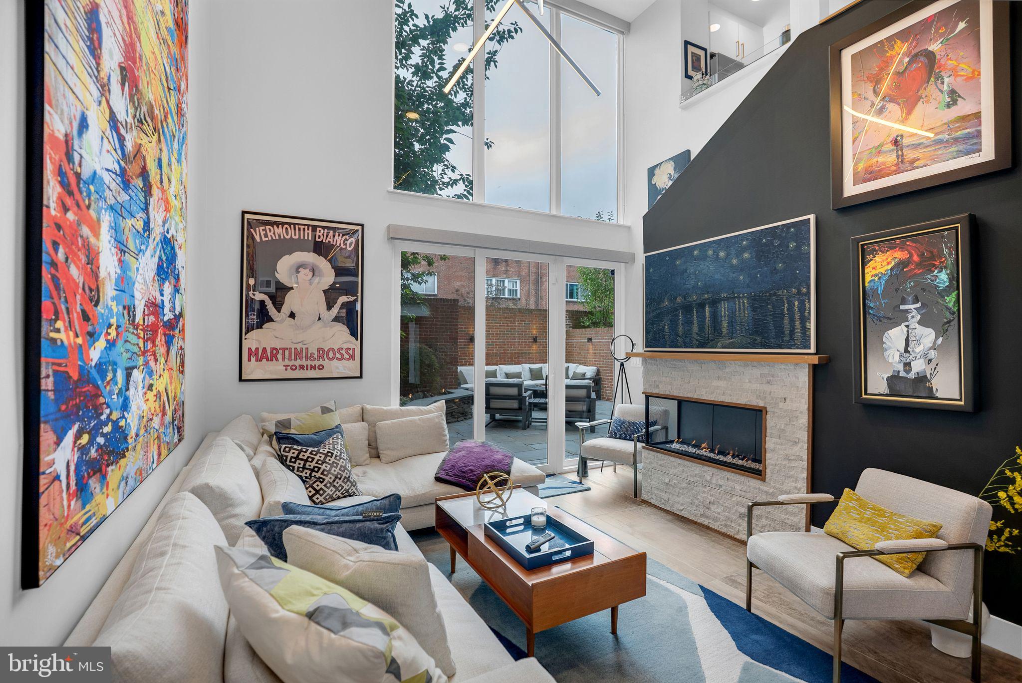 Serene Outdoor Space and Oversized 1 Car Attached Garage Parking! Experience the epitome of luxury and function in this architectural gem on Addison St. This 26-foot-wide brownstone, beautifully renovated between in 2023, offers 2,091 square feet of exquisite living space. It harmoniously combines contemporary design with mid-century modern elements, showcasing elegance and sophistication at every turn. As you enter, you'll be captivated by the soaring two-story ceilings and a magnificent wall of floor-to-ceiling glass that bathes the interiors in natural light, creating a spacious and inviting atmosphere. The great room, with its striking two-story fireplace, stands as the home's impressive centerpiece. Nearby, a cozy living room extends from the kitchen and dining area, providing the perfect setting for intimate gatherings and relaxation. This home boasts three elegantly appointed bedrooms, including a luxurious primary suite featuring a spa-like ensuite bathroom with heated floors and an oversized custom frameless glass shower. The chef's kitchen is a true culinary haven, complete with a breakfast bar, coffee bar, oversized island, and premium quartz countertops with a dramatic slab backsplash stretching to the ceiling. This well-designed space seamlessly connects to the dining area, making entertaining a delight. Every detail in this residence has been thoughtfully curated, from the exquisite finishes of ceramic, concrete, hardwood, and stone floors to the ambient lighting provided by chandeliers, recessed lights, and a skylight. The home offers ample storage with custom and walk-in closets, along with the convenience of a third-floor laundry room and a utility room behind the garage. Step outside to your serene private patio — a true backyard oasis. The unique bluestone design, mature landscaping, custom exterior lighting, and inviting garden beds create an ideal space for both entertaining and peaceful relaxation. The fully walled-off brick design ensures privacy, while the attached garage, spacious enough for a full-size SUV, enhances convenience and accessibility. This exceptional townhouse is a rare opportunity to own a piece of architectural brilliance, offering an elevated lifestyle in a prime location. With its timeless design and meticulous attention to detail, it stands as a testament to luxury living.