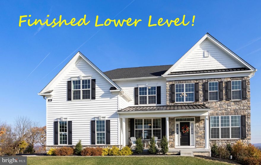 Luxury living in the sought-after Preserve at Kimberton Glen community! This 2-year young home also sits on a large, bucolic lot backing to open space & trees, with the most stunning Chester County vistas & sunrise views! With 5/6 BEDROOMS, and 5 FULL BATHS, and a magnificently FINISHED WALK OUT LOWER LEVEL, this home showcases a series of formal and casual living spaces --- infinite possibilities for everyday enjoyment & relaxing & entertaining! Plus just minutes to all the fun of downtown Phoenixville, and also the Schuykill River Trail, French Creek Trail and Valley Forge National Park. Such striking curb appeal, with the gorgeous stone & siding elevation and also the expansive COUNTRY PORCH accented by white pillars and a black metal roof. The stylish front door with sidelites & transom windows leads into the two-story RECEPTION FOYER that is awash in natural light, and includes an exquisite curved staircase with wood treads and balusters. Bonus --- both this main floor (10-ft ceilings) and the second level (9-ft ceilings) are replete with gleaming hardwood floors! The open lay-out continues into the sophisticated LIVING ROOM and elegant DINING ROOM, both featuring arrays of sunlit triple windows. The dramatic two-story FAMILY ROOM showcases a mantled gas fireplace flanked by soaring sun-filled windows, and adjacent is the OFFICE with large closet plus a FULL BATH with dual entry --- so can also be a BEDROOM SUITE! The spacious BREAKFAST ROOM includes slider doors with transom windows leading out to the new deck! This KITCHEN is truly the heart of the home --- an expansive gourmet haven where culinary creativity meets luxurious upgrades! A sizeable center island with sit-up breakfast bar; onyx toned granite counters which complement the white soft-touch, raised panel cabinetry & white subway tile backsplash; stylish stainless steel fixtures; large pantry; deep basin farmhouse sink with Kohler faucet; and stainless steel appliances including 5-burner gas cooktop with SpeedHeat and AccuSimmer, commercial-style range hood, double wall oven/microwave oven, and LG fridge with InstaView glass panel. Also on this floor: MUDROOM w/laundry, closet, and access into the oversized GARAGE. Up the curved staircase and the upstairs has beautiful hardwood floors and a welcoming landing/catwalk. The PRIMARY SUITE features a BEDROOM; comfortable 13x10 SITTING ROOM flanked by millwork columns; WALK-IN and bonus closets; a quiet VANITY AREA to primp & pamper; and a large FULL BATH with 2 distinct vanity/sink areas, soaking tub, stall shower, and private WC. Down the hall are 3 more BEDROOMS, all with ample closets --- one is en-suite with its own FULL BATH w/tub/shower combo, plus there is an additional hall FULL BATH w/tub/shower combo. Retreat downstairs to explore the fun of your FINISHED WALK OUT LOWER LEVEL, showcasing an amazing fusion of entertainment areas! There is a GAME/FITNESS AREA (currently being used as an indoor pickleball court!); a REC AREA that includes a fabulous sit-up WET BAR with granite counters w/under cabinet lighting, a wine fridge, and a dishwasher; a FULL BATH with tub/shower combo; and a BONUS/FLEX ROOM that has a large window and could be an Office or potential 6th Bedroom! The HOME THEATER provides a cinematic escape, and is also ideal for enjoying game day fun & series binge-watching & gaming! Luxury vinyl plank flooring; extra recessed lighting; abundant storage space; and slider doors out to the yard complete this level. The new oversized composite DECK with vinyl railings has steps down to the premium lot with extra grassy yards backing to woods & open space. So much more: shaker-panel 8 ft interior doors; millwork accents & designer lighting throughout; 3 HVAC zones; whole home humidifier; and so much new because the house was just built 2 years ago! Conveniently located to Routes 422 & 202 & 29, PA Turnpike, and everywhere you want to be! Some exterior photos virtually staged.