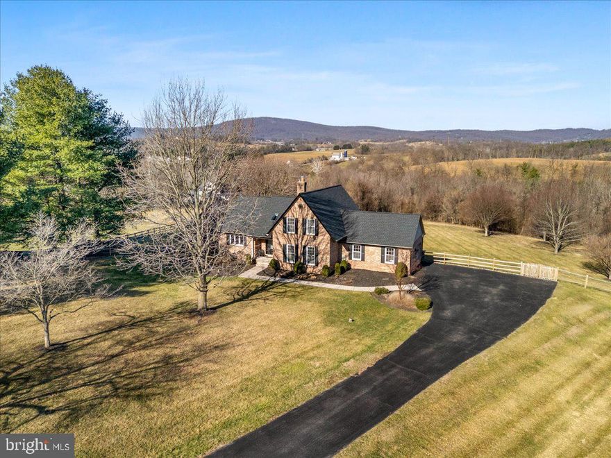 Tucked away on a quiet cul-de-sac in sought-after Middletown, this exceptional custom-built Cape sits on 3.16 private acres, offering a rare blend of privacy, open skies, breathtaking sunset skies, and scenic South Mountain views. Designed to bring the outdoors in, the home captures its natural surroundings from nearly every angle—creating a seamless connection between interior living spaces and the expansive landscape beyond. From the moment you arrive, there’s an unmistakable sense that this setting is different—peaceful, expansive, and quietly extraordinary, yet just minutes from everything Middletown has to offer.  The spacious 18' x 14' screened porch, complete with heaters and new stairs leading to the fenced yard, defines the lifestyle this property offers—where sunset views and the backdrop of South Mountain become part of your daily routine, and the firepit area and open acreage create seamless indoor-outdoor living in every season. Whether hosting friends or enjoying a quiet evening at dusk, the setting invites you to slow down and be present.  Inside, the open and flowing floor plan features a first-floor primary suite, main-level laundry, vaulted ceilings, and a flexible upper level ideal for guest space, a home office, or creative retreat. Fresh paint, new luxury vinyl plank flooring, and new carpet create a cohesive, refreshed feel. A stone fireplace anchors the family room, while custom built-ins in the living room add warmth and timeless character. Updated lighting throughout enhances the home’s style with a clean, polished finish. The kitchen offers granite countertops, an induction cooktop, and a functional layout that connects seamlessly to surrounding living spaces with easy access to the screened porch for true indoor-outdoor flow.  Beyond its beauty, the home reflects substantial recent investment and meaningful upgrades, including a new roof and gutters, screened porch improvements with dual 240V lines and heaters, new electrical panel wired for generator, fully insulated and finished garage with recessed lighting and Tesla charger, HVAC HEPA cleaning and system updates, well pump and pressure tank replacement, updated primary bath plumbing, new water heater, windows, doors, and rear siding.  Properties offering this level of acreage, privacy, South Mountain views, and thoughtful improvements are rarely available in Middletown. 3293 N Hill Court is more than a home—it’s a setting, a view, and a feeling that stays with you long after you leave.