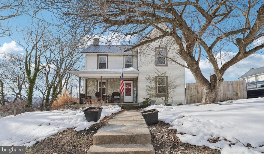 Welcome to 519 N Maple Ave, a classic 4-bedroom, 3-bath colonial set on a corner lot in the heart of Brunswick. The home offers a traditional layout with comfortable living spaces and a setting that feels established, walkable, and connected to the surrounding neighborhood.

The main level centers around a welcoming family room with a stone fireplace that gives the space a comfortable, lived-in feel. A separate dining room provides room for everyday meals and gatherings and leads into the kitchen, which features granite countertops, stainless steel appliances, and access to the side yard. Vinyl plank flooring runs through the main living areas in a neutral finish. The primary bedroom is also located on this level with an attached full bath featuring double sinks, a walk-in shower, and a large closet. A second full bath and laundry area complete the main floor.

Upstairs, three additional bedrooms and a full hall bath provide flexible space for guests, work-from-home needs, or additional living areas. The rooms are well-sized and filled with natural light, offering a quiet retreat from the main level.

Outside, the property includes an adjacent, separately deeded wooded lot that adds privacy and green space—an uncommon feature for an in-town home and one that gives the yard a more open, secluded feel without losing proximity to town amenities.

Located in an established residential part of Brunswick, the home is within walking distance to local shops, schools, parks, the library, and downtown Brunswick. The MARC train station is just over half a mile away, and Routes 340, 15, and I-270 provide convenient access toward Frederick, Montgomery County, and Northern Virginia.