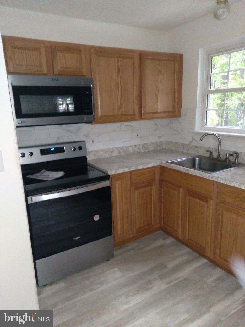 This beautifully remodeled garage apartment is the perfect blend of privacy, style, and functionality. Updated less than two years ago, this inviting and open space features a brand-new kitchen with modern cabinets, updated appliances, and sleek new flooring throughout. A dedicated, full-sized washer and dryer add to the convenience, making laundry day a breeze. The apartment also includes an additional room perfect for a home office or an extra guest, offering extra flexibility for your lifestyle needs. Enjoy a clean, well-maintained space that feels like home the moment you step inside!