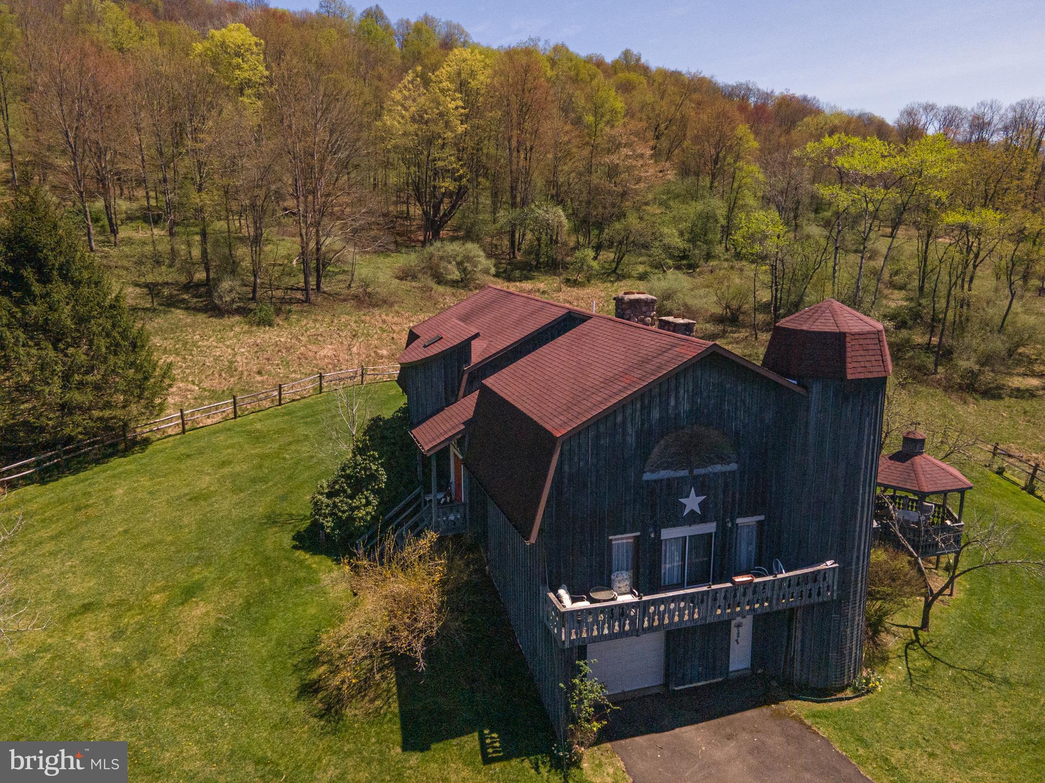 This rare property includes a large lodge in remote Tioga County
bordering Pa State Game Lands. The 2 story lodge/house has 5,043 sq. ft. of living quarters
plus a full basement with 5 bedrooms,3 bathrooms along with a master suite with fireplace and
hot tub, a library and game room. This interior of home has a hand made spiral oak stairscase,
fireplace built with 2’ thick stone dug from property, entry way floor is brick all from a historic
movie theater in downtown Galeton that burned down, ceiling is 6” thick tongue and groove
hardwood, peak of living room has stained glass window representing the four seasons. Kitchen
includes commercial Vulcan oven, sunk in seating area and antique wood fired oven in mint
condition connected to a brick warming oven in dining room. The exterior of home is rough cut
lumber with 2 silos one on each side serving as staircase to each floor of home. The home is
heated with geo-thermal heating system along with air condition. There is both spring water
and water well with complete filtration system along with UV light. This all sits on +/-91 acres
of land enrolled in Clean and Green that consists of a mix of mature hardwoods, early
succession, open fields and orchard , with direct remote access to 7000 acres of bordering Pa
State Game Lands. Mature hardwoods consists of a mix maple, cherry and beech with beautiful
stream and small water falls running through. The 2 open fields would provide approximately 6
acres great food plots located in middle of property. Early succession has several apple trees
along with pear trees. All of this is within 2.5 miles of Route 6 and Pine Creek which is known
for its endless recreation opportunities which include great fishing, canoeing and kayaking
along with being just short drive to thousands of acres of Tioga State Forest land with miles of
hiking trails and along with the Pa Grand Canyon. This is a must see for anyone seeking year
round recreation, call today for a showing.