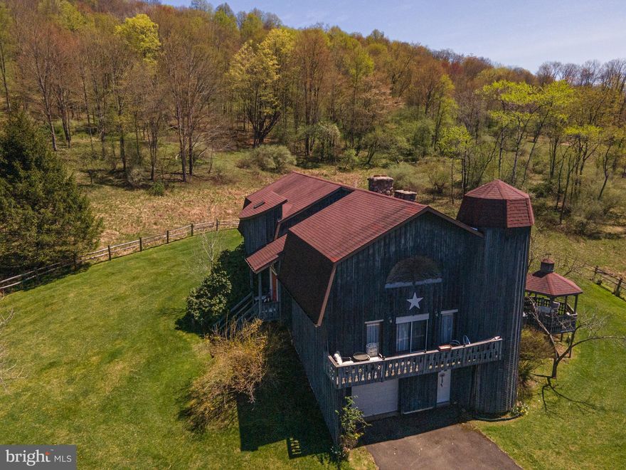 This rare property includes a large lodge in remote Tioga County
bordering Pa State Game Lands. The 2 story lodge/house has 5,043 sq. ft. of living quarters
plus a full basement with 5 bedrooms,3 bathrooms along with a master suite with fireplace and
hot tub, a library and game room. This interior of home has a hand made spiral oak stairscase,
fireplace built with 2’ thick stone dug from property, entry way floor is brick all from a historic
movie theater in downtown Galeton that burned down, ceiling is 6” thick tongue and groove
hardwood, peak of living room has stained glass window representing the four seasons. Kitchen
includes commercial Vulcan oven, sunk in seating area and antique wood fired oven in mint
condition connected to a brick warming oven in dining room. The exterior of home is rough cut
lumber with 2 silos one on each side serving as staircase to each floor of home. The home is
heated with geo-thermal heating system along with air condition. There is both spring water
and water well with complete filtration system along with UV light. This all sits on +/-91 acres
of land enrolled in Clean and Green that consists of a mix of mature hardwoods, early
succession, open fields and orchard , with direct remote access to 7000 acres of bordering Pa
State Game Lands. Mature hardwoods consists of a mix maple, cherry and beech with beautiful
stream and small water falls running through. The 2 open fields would provide approximately 6
acres great food plots located in middle of property. Early succession has several apple trees
along with pear trees. All of this is within 2.5 miles of Route 6 and Pine Creek which is known
for its endless recreation opportunities which include great fishing, canoeing and kayaking
along with being just short drive to thousands of acres of Tioga State Forest land with miles of
hiking trails and along with the Pa Grand Canyon. This is a must see for anyone seeking year
round recreation, call today for a showing.