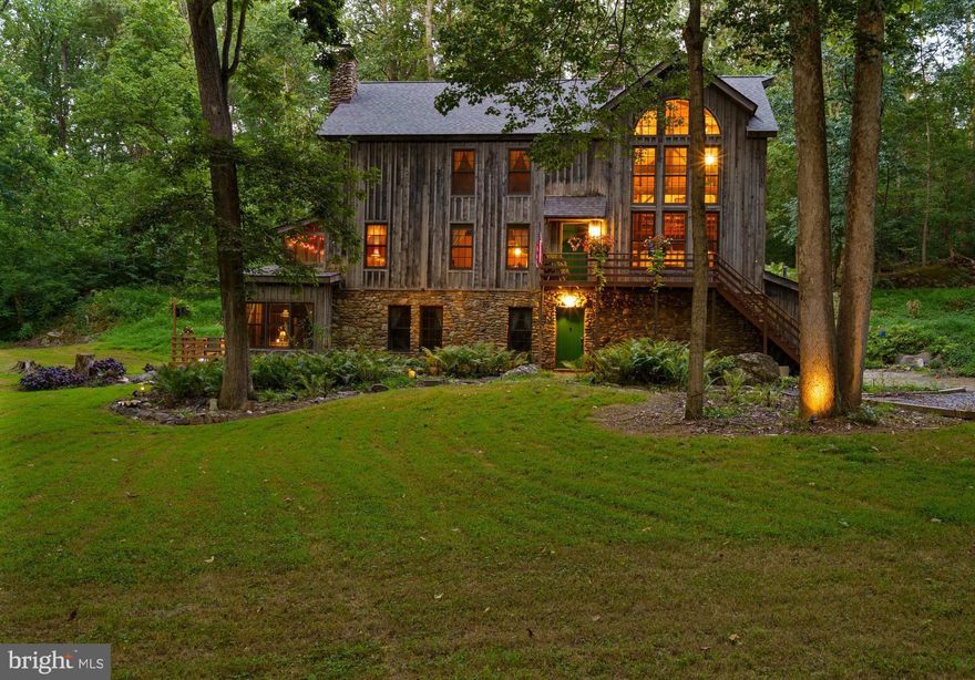 MAJOR PRICE IMPROVEMENT!  Seller is in the process of relocating.   Welcome home to Shepherdstown - West Virginia’s oldest town full of immeasurable history, arts, charm, and uniqueness!  This is your chance to escape all the hustle and bustle to discover this exceptional timber frame retreat-style property located in historic Shepherdstown!  With almost 3,200 square feet of meticulously crafted living space,  the "Felsig Platz" residence retreat is a custom-built timber frame home that offers 5 bedrooms, 3.5 baths, rich custom woodwork, a rare blend of artisanal detail, luxurious comfort, and serene natural beauty all privately situated on 2.42 wooded acres just minutes from the heart of historic Shepherdstown and near by Potomac River.  This is a truly unique property!

At the heart of the home, a soaring great room is anchored by vaulted ceilings and a grand stone fireplace—an impressive focal point that showcases the warmth and character of true timber frame architecture. The gourmet kitchen, dining room, and open living spaces flow effortlessly into expansive outdoor decks, offering ample room to relax, entertain, and take in the surrounding tranquility.  Continuing on this level is a quaint bedroom and a convenient half bath that features laundry access.  The charming screened porch is adjacent and accessible from this level.

Upstairs is an open sitting room area that overlooks the great room.  Down the hallway is a bedroom that offers relaxing comfort and sufficient closet space and is located next to the hall bathroom.  The true charmer on this level is the elegant primary suite that features a bedroom, generous closet space, and bathroom complete with separate vanities, a large jacuzzi tub, and thoughtful design elements that create a spa-like experience.  The primary bedroom extends to an upper level for more finished bonus space, more closets, plus work/hobby space.   

The connecting, fully-finished lower level includes private living quarters complete with dual outside entrances and a kitchen that is ideal for guests, extended family, or flexible use as a studio,  home office, or an Airbnb.  Worth noting... this level has functioned as a viable, income-producing Airbnb space over the past few years.  Rounding out this unique property is the spacious detached outbuilding that provides endless potential—perfect for a studio, workshop, or easily converted into additional living or creative space.

Combining timeless craftsmanship, modern amenities, and a peaceful setting, this exceptional property delivers an elevated lifestyle just moments from the vibrant culture, dining, shops, and historic charm of Shepherdstown plus convenience to the Potomac River, C&O Canal, Antietam National Battlefield, Shepherd University, National Conservation Training Center, Cress Creek Country Club, Bavarian Inn Resort, nearby MARC Train, and so much more.  Contact today to book a showing!