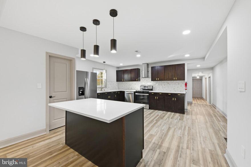 Price Adjustment!!  This spacious 5 bedroom/3 bath home blends modern finishes with a classic design. Completely gutted and renovated with new framing, sheet-rock, electrical and plumbing.   Luxury vinyl plank flooring, recessed lighting and new two panel doors are found throughout the home. The stunning kitchen with Quartz countertops, shaker cabinets, new appliances, and a coffee bar is ideal for dining, and entertaining. Four spacious bedrooms and 2 full bathrooms are located on the main level.  The entire second floor is a huge master suite with walk-in closet, sitting area and gorgeous private bathroom. Ample storage is available in the finished attic. In addition to the amazing renovations, big tickets items have also been taken care of with a new roof, central A/C, furnace and hot water heater(2025), and energy saving Pella windows. In a great location with access to Rte 295 and NJ Tpke and near downtown Mount Holly which offers many restaurants and features community events throughout the year.