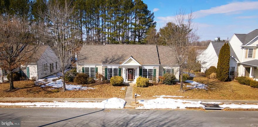 Welcome to this beautifully appointed 2 bedroom, 2 bathroom single-level home in the sought-after Easton Club East community, offering comfort, style, and abundant natural light throughout.
A welcoming foyer sets the tone, with a library on the right and dining room on the left, and the living room straight ahead, which impresses with a tray ceiling, crown molding, and classic wainscoting, creating an ideal space for entertaining. The spacious main living area features a vaulted ceiling, cozy gas fireplace, and direct access to the patio, seamlessly blending indoor and outdoor living. The stunning designer kitchen is a true centerpiece, showcasing upgraded quartz countertops, white cabinetry, stainless appliances, and a large center island with designer pendant lighting and counter seating—perfect for casual dining and gathering. The primary suite offers plush carpeting, a generous walk-in closet, and French doors leading to a luxurious ensuite bath complete with a corner soaking tub framed by windows, separate vanities, a step-in shower, and a private water closet. Additional highlights include a 2-car rear-entry garage and a fenced backyard for added privacy and outdoor enjoyment. Residents of Easton Club East enjoy exceptional amenities, including a clubhouse with a ballroom, game room, and fitness center, as well as tennis and pickleball courts and a refreshing outdoor pool. Special note: this property is exempt from the 55++ requirement for residents. Ideally located just minutes from Route 50 and all that Maryland’s Eastern Shore has to offer, this home combines relaxed coastal living with everyday convenience.