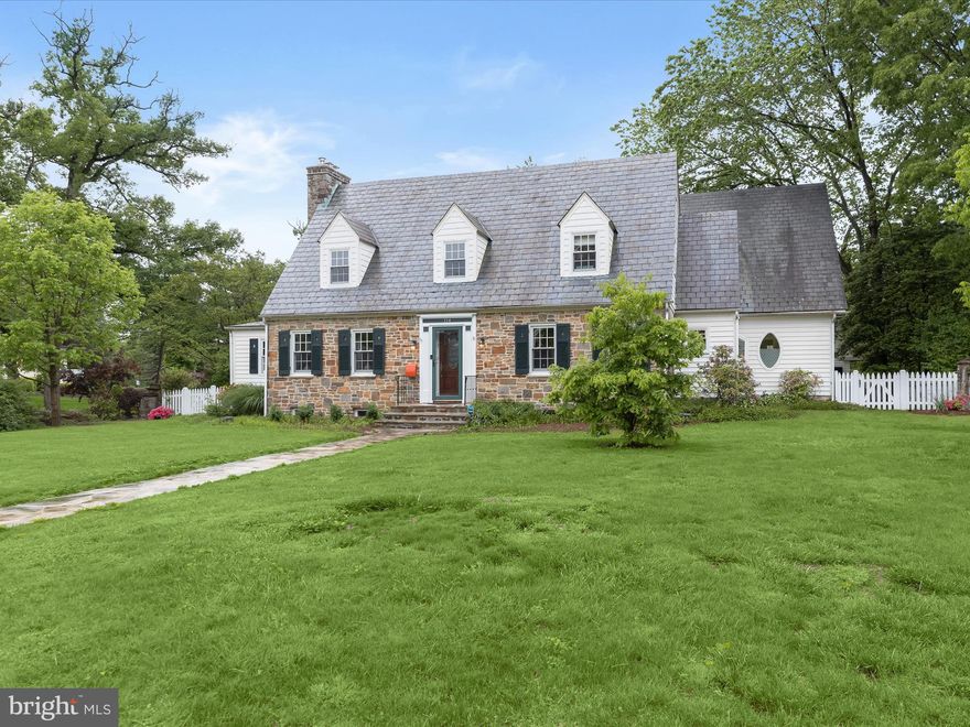 Offer Deadline is Monday 6/2/25 at noon.  Square Footage on Tax Record is not accurate.  Estimated above grade square footage is 3,435.   Introducing this exceptional 4-bedroom, 3 full and 2 half-bath “Catonsville Classic” — a timeless residence that blends refined elegance with casual comfort. With just three owners in its 85-year history, this home showcases enduring quality and consistent care. Perfectly positioned on a beautifully landscaped corner lot, this home is surrounded by lush gardens and thoughtfully designed hardscaping, offering both charm and privacy. Step inside to a warm foyer featuring rich hardwood floors and a soothing neutral palette that sets the tone for the sophisticated interiors. The light-filled living room, framed by classic chair railing and expansive windows, flows seamlessly into the heart of the home — a stunning gourmet eat-in kitchen. Designed for both beauty and function, the kitchen features crisp white display cabinetry, sleek granite countertops, and a decorative tile backsplash that adds texture and style. Modern stainless steel appliances include a SMART refrigerator with touchscreen convenience and a whisper-quiet, energy-efficient dishwasher. A peninsula island adds extra workspace and casual seating, perfect for morning coffee or conversation while cooking. Adjacent to the kitchen is a dining area that easily accommodates both everyday meals and festive gatherings. The family room offers a cozy yet elegant setting with deep-set windows overlooking the gardens and a show-stopping Breche marble, Louis XVI-inspired wood-burning fireplace — a true focal point that brings warmth and sophistication to the space. Nearby, the private office is a retreat of its own, featuring natural stone flooring and rich beadboard wood ceiling— ideal for working from home or quiet reflection. The main-level primary suite offers serene views of the grounds, a spacious walk-in closet, and a spa-like en suite bath with a soaking tub, walk-in ceramic tile shower, and dual vanities. A stylish powder room and a practical entry/mudroom complete the main level. Upstairs, three generously sized bedrooms await, including one with a private en suite bath — perfect for guests or multigenerational living. A full hall bath and a laundry room with cabinet storage provide added convenience and functionality. The lower level expands your living options with knotty pine walls, stone-patterned flooring and a second wood-burning fireplace, making it an inviting space for a recreation or game room. A separate utility area with bathroom facilities complements the finished basement space. Equipped with a state-of-the-art geothermal heating and cooling system, this home ensures year-round comfort and exceptional energy efficiency.  Adding even more appeal is the detached garage with a fully equipped guest suite above. Featuring a private entrance, living area, kitchenette, and full bath, this space is perfect for visitors, an au pair, or as a private home office.  Outside, the corner lot enhances the home’s sense of openness. Enjoy the outdoors on the platform deck — perfect for stargazing — or the custom stone patio with a pergola and relaxing hot tub. Manicured landscaping and multiple gathering spaces invite you to appreciate the beauty of each season. A private rear entrance to the garage offers added convenience and discretion. Recent updates include a SMART refrigerator and high-efficiency dishwasher for modern convenience, a gas washer and dryer for fast, eco-friendly laundry, and a fully redone and re-mortared patio — enhancing both aesthetic appeal and long-term value.