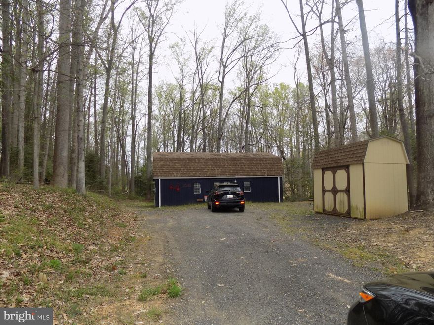 Solid 2 story (36'x24') Amish built workshop on 1.21 Acres. Features open floor plan with electric and built-in Heat and A/C. First floor features Taupe Oak vinyl flooring and wainscoting. Many electrical outlets throughout.  Upper level offers ample storage.  Public water available. Potential Septic Installation Plat uploaded under Documents.