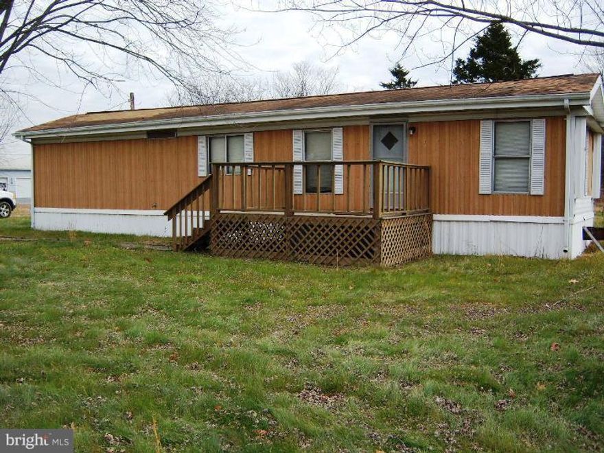 Single Wide mobile home on one open acre with two car detached garage and carport, separate one car garage, private well and septic located close to the Cacapon State Park and minutes from Winchester VA.