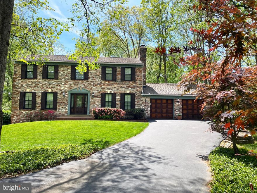 A true Great Falls gem in the Langley school pyramid, loaded with custom, luxury upgrades and an expanded floor plan on an exceptional, wooded lot, situated at the end of a private cul-de-sac. Backs to wooded common area with miles of private hiking trails and a community lake. This stately brick colonial, with raised panel hardwood shutters and garage doors, welcomes you with a custom mahogany front door with 3/4 insulated arcadia glass and sidelights by Pella, and high performance Anderson windows with maintenance free fiberex sashes, energy efficient low E-4 SmartSun glass, 3-D mullions inside and out and large plantation shutters. The mature landscape, Certainteed dimensional Landmark TL shingle roof and Leafguard gutters invite you in to explore the immaculate gourmet kitchen, which boasts a Jenn-air cooktop, energy efficient GE Monogram stainless steel double convection ovens, warming drawer, side by side refrigerator with water & ice dispenser, a dishwasher and a large double sink. The abundance of cabinets/counters and neutral ceramic floor make meal prep and clean up easy. The breakfast bar opens to the sunroom & great room with cathedral ceiling, skylights and French doors adjacent to an expansive deck overlooking an exquisite view of wooded common area. The main floor has a formal living room, dining room with Spectra crystal chandelier, and family room with masonry fireplace & mantel, all with crown molding, laundry room with gray tone Electrolux washer & dryer and new stainless steel utility sink. Red Oak Hardwood covers the main level and upper level floors, except for the main floor powder room which includes a pedestal sink & Italian versailles laid travertine. The master suite includes crown molding, a fireplace, a shower with a rainhead, a shower wand and bench, two closets (1 walk in with custom closet system) and a dressing room with beautiful custom wall mirrors, hardwood cabinets with granite countertop and double sinks, natural lighting provided by energy efficient suntunnels. Upstairs also includes 3 bedrooms and a full bath with double sinks, granite countertop, custom cabinets & mirrors and soaking tub. All bathroom fixtures by Kohler. The fully finished walkout basement is beautifully appointed and consists of a large 5th bedroom, a game/recreation room with masonry fireplace & mantel, a full bath and a large homeoffice/gym/den or optional 6th bedroom. There is even a sizable storage room with floor to ceiling shelves. The dual zone HVAC with programmable thermostats and numerous ceiling fans creates a well-balanced, comfortable home. The oversized 2 car garage has its own electrical panel to handle the most demanding power tools and additional lighting transforms the garage into true workspace.