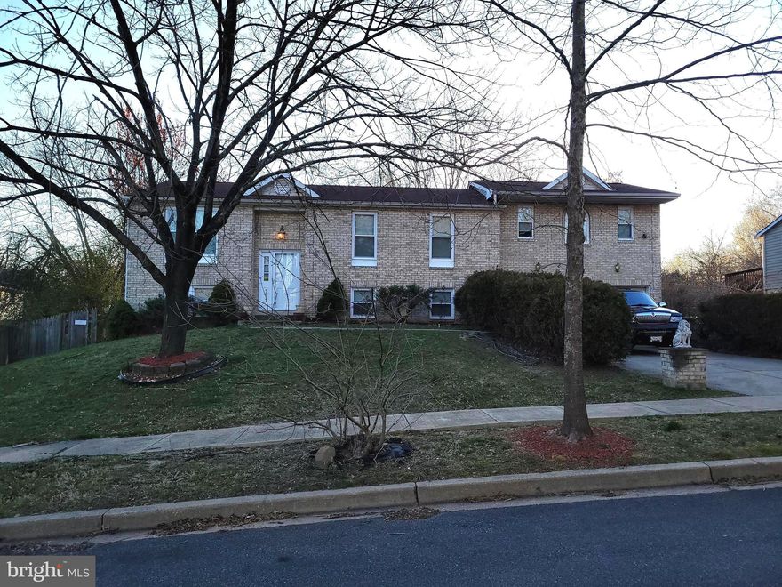 This mostly brick, 5-bedroom home with 3 full bathrooms, and an attached 2 -car garage was completely rebuilt on the main level and the basement in 2022.    Gleaming hardwood floors in living room, kitchen, and hallway with a complement of beautiful, "walk the red carpet."  This home has a beautiful, upgraded kitchen with premium stainless-steel appliances, a master bedroom with a large sitting room, a very large master bathroom with a heart shaped tub with jets and a separate shower.  Numerous new recessed lightings complement the newly rebuilt home and are exhibited throughout the entire home.  The hall bathroom has been upgraded with a beautiful ceramic tile pattern and also has a large combination bathtub and shower with jets.  The full finished basement consists of two large bedrooms, a full bathroom, family room, and storage/washroom.   Heat Pump, Furnace, and Hot Water Heater is one year old.   Walk out the sliding glass doors from the dining area to a very large wooden deck.  The more than 12,000 sq ft lot is fully fenced-in, has two storage sheds, a ground level deck in rear of yard, and an unused fenced in dog kennel.