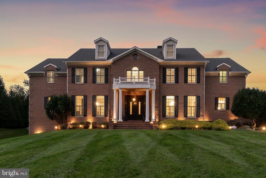 Experience the pinnacle of luxury in this one-of-a-kind custom brick colonial, where timeless elegance meets modern convenience. Nestled on a beautifully landscaped property, this stately residence offers a masterful blend of comfort, sophistication, and exquisite design.

The first floor features a spacious primary bedroom suite, complete with walk-in closets and a luxurious bathroom that offers serene views of your private backyard oasis. This tranquil retreat is just the beginning of what this exceptional home has to offer.

As you enter through the grand foyer, the wide-planked hardwood floors draw you into the heart of the home. The living room, with its breathtaking 28-foot ceiling, exudes grandeur while maintaining an inviting atmosphere. Three fireplaces throughout the home and a fourth outside add warmth and charm, making every room feel cozy and welcoming.

For the culinary enthusiast, the kitchen is a dream come true. Outfitted with top-of-the-line appliances, it’s designed to inspire your inner chef, with ample space for entertaining or preparing intimate family meals. The kitchen’s seamless flow into the dining and living areas ensures that the heart of the home is always connected.

Each of the six generously sized bedrooms is a private haven, complete with its own ensuite bathroom and walk-in closet. Two of the upstairs bedrooms offer additional rooms that are ideal for a study, a playroom, or a space to showcase your favorite collections. The home’s thoughtful design extends to the upper level, where a rear staircase leads directly to the media room. This large, versatile space is perfect for movie nights, equipped with a projector, screen, wet bar, pantry, and a substantial storage closet.

Everyday living is made easier with two laundry rooms, one conveniently located on the main floor near the garage and the other on the upper level. The fully finished basement, with its 10-foot ceilings, provides an expansive area for recreation and relaxation, offering endless possibilities for your family’s favorite activities.

The exterior of the home is equally impressive, designed for both relaxation and entertainment. The three-car side garage accommodates even the largest of vehicles or recreational toys, while the backyard offers a resort-like escape. Unwind poolside, or enjoy year-round outdoor living with the fully equipped kitchen and bar. The entire property is enhanced by a whole-house sound system, creating the perfect ambiance for any occasion. Additionally, two well-appointed sheds with electricity provide ample space for storage or hobbies.

This custom brick colonial is more than just a home; it’s a lifestyle. Every detail has been carefully considered to offer the perfect balance of elegance and functionality, ensuring that you’ll enjoy this remarkable residence for years to come. Don’t miss the opportunity to make this exceptional property your own.