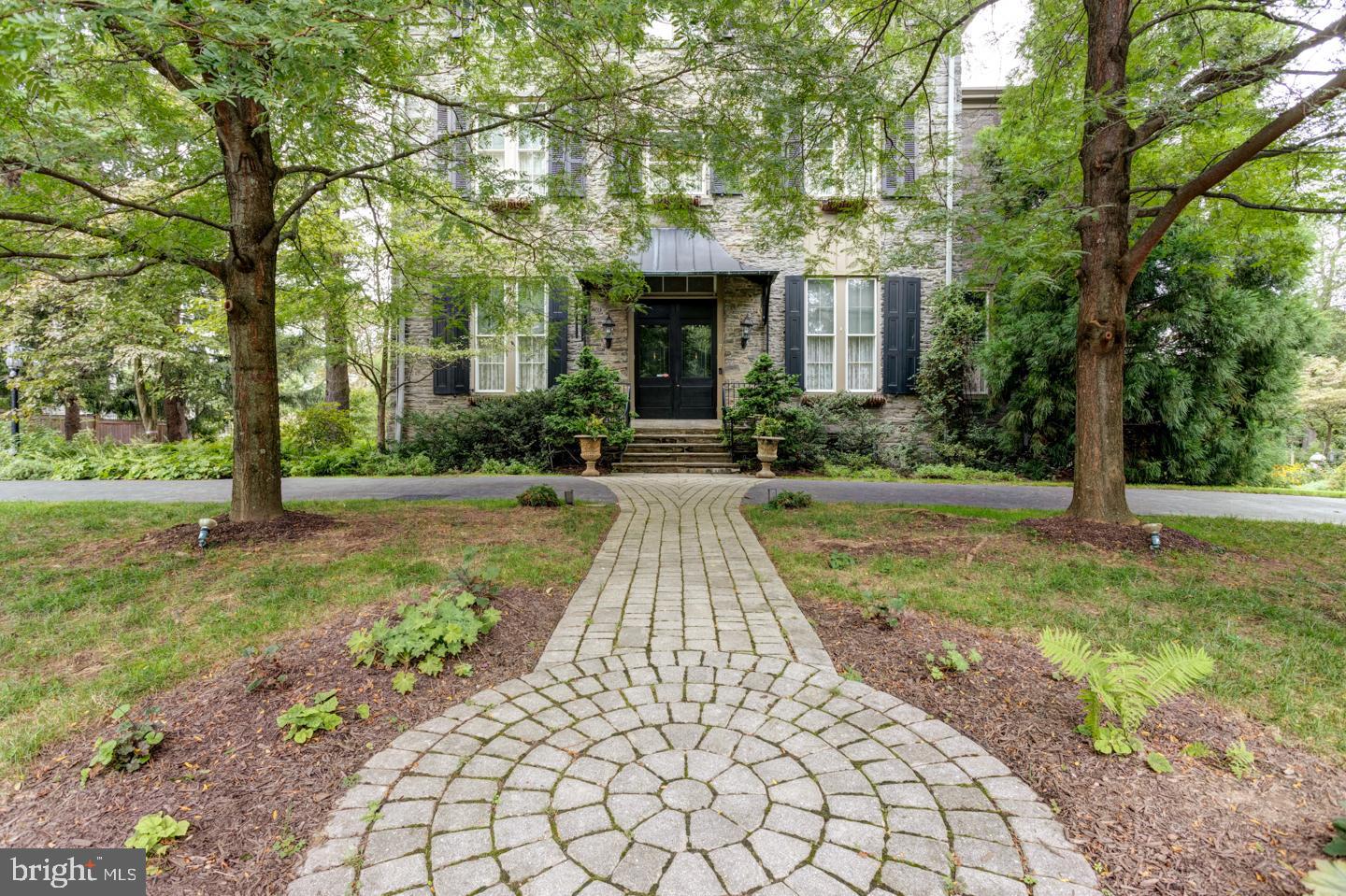 Welcome to 21 Summit Street - Built in 1857, this 6 bedroom 4.5 bath Italianate Victorian stone masterpiece is believed to be the highest point of natural land in the city of Philadelphia. Built as a summer home for Samuel Austin, a Philadelphia attorney who purchased the land between the two Chestnut Hill railroad stations, the house has a walk-to-everything location that cannot be beat. You are greeted by soaring ceilings, gracious light-filled spaces, incredible original detail, millwork and hardwood floors throughout. The grand dining room is open to the renovated Chefs kitchen (2007) equipped with tons of cabinet space, high-end appliances including a SubZero refrigerator, Dacor range, Bosch dishwasher, a fireplace, island workspace, a desk area and a door to the back deck. Beyond the kitchen, enjoy the choice of two wonderful living spaces. The cozy den/living area with a fireplace and built-ins OR step up to the expansive solarium room of the addition with walls of windows and access to the outdoor wrap around mahogany deck with a cedar Pergola. The second floor offers 3 spacious bedrooms each with its own bathroom/suites including a lovely master bedroom with a walk-in closet and a newly renovated bathroom that offers two sinks, a walk-in seamless shower, gorgeous fixtures, tasteful finishes and radiant heat floors. The 2nd floor room of the addition is another sun drenched room with walls of windows and built-in cabinets/bookcases; perfect for an at home office or studio space. Three additional bedrooms and a renovated hall bath complete the third floor. Lets not forget the best part... access to the railing-enclosed platform on the roof. One can see the fireworks on the Delaware River on New Years Eve! Improvements include, three new natural gas high efficiency furnaces and two new central air conditioners, installed 2019, a resurfaced rubber roof in 2012 (coated in 2020), knob and tube wiring removed, new mahogany wrap around deck with cedar Pergola in 2011, new gas log set in den fireplace 2020, 400 bottle gated wine cellar remodeled 2018. Walk to EVERYTHING with it's Top of the Hill location (literally), including the R8 & R7 Septa rail lines, steps to Germantown Avenue's shops and restaurants, walkable to the Wissahickon trails, the Morris Arboretum, Woodmere Art Museum and so much more! This home is Historically registered.