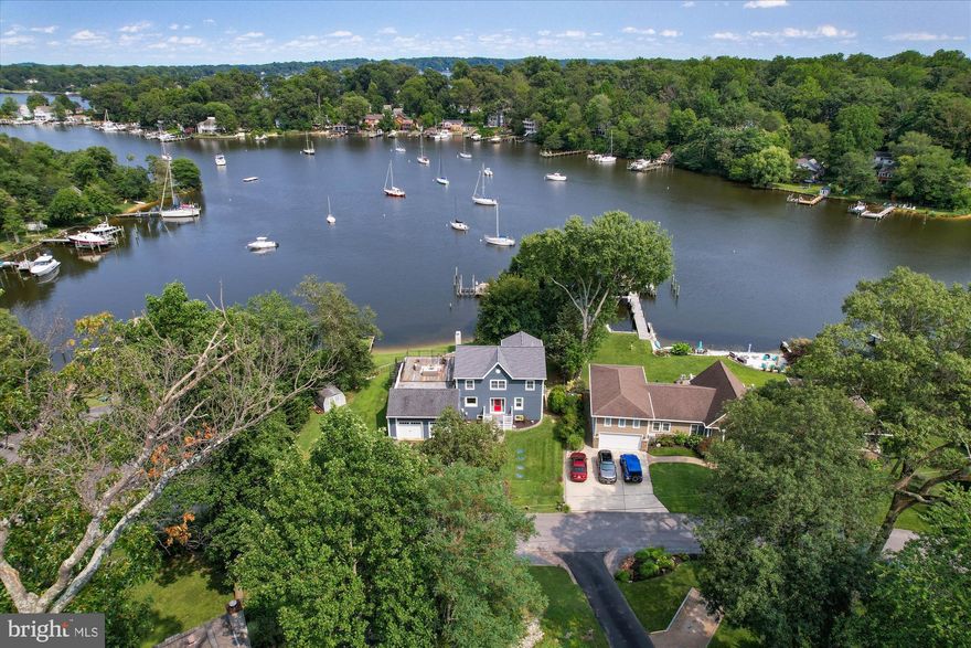 Discover the epitome of waterfront living in this captivating home nestled along the shores of Valentine Creek. Boasting a deep-water pier with slips and a boat lift, this property offers not just a home, but a lifestyle. Ascend a few stairs to your private beach, a serene retreat just steps from your door. 

This meticulously designed residence features a 2-car garage, 3 bedrooms, and 3 full bathrooms. The upper level is a sanctuary, exclusively dedicated to the owner's suite. Revel in luxury with an extra-large bathroom, complete with a soaking tub, a custom walk-in closet, and the convenience of an adjacent laundry room. The living room on this level provides a panoramic view of Valentine Creek, creating a tranquil escape within your own home. 

On the main level, two bedrooms, a full bathroom, and a spacious living room complement the heart of the home—a chef's kitchen adorned with red Birch cabinets, granite countertops, and tiger wood floors. A sitting area and dining space overlook the picturesque Valentine Creek, making every meal a scenic experience. 

The fully finished walk-out lower level is a haven of entertainment, offering a recreation room, additional storage, and another full bathroom. Step outside to enjoy the waterfront ambiance or ascend to the rooftop deck accessible from the upper-level living room—a perfect vantage point for sunset views. 

Crafted for comfort and durability, the hardy plank siding ensures not only a sturdy exterior but also contributes to sound reduction. With approximately 3,800 sq. ft. of finished living space, this home has been completely updated to meet the highest standards of modern luxury. 

Located in the coveted neighborhood of Arden on the Severn, residents enjoy exclusive access to five beaches, three boat ramps, and a vibrant community association hosting events throughout the year. Embrace the coastal lifestyle, where every day feels like a vacation in this waterfront haven.