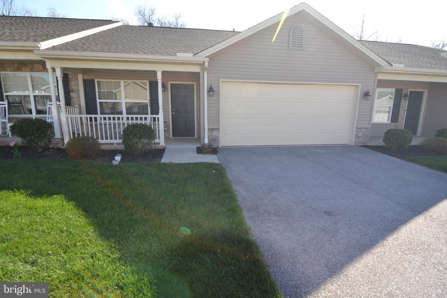 Rare availablity in this 55 + community. Boasts 2 bedrooms and 2 full baths with a modern eat-in kitchen, including granite countertops.  Large living room has 3-way gas fireplace and open to dining area.  Laundry room is right off the 2-car garage (with attic access).  Covered front porch and back patio complete this comfortable living space.  This estate is being sold as-is.