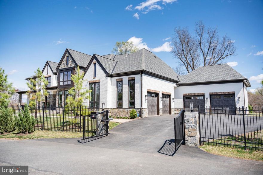 NEW PRICE - Welcome to 1109 Towlston Road, an extraordinary custom residence crafted by the renowned builder, Versailles Homes. This all-brick and stone masterpiece seamlessly blends timeless elegance with modern sophistication, offering over 9,700 square feet of luxurious living space. Designed for both everyday comfort and grand-scale entertaining, this home leaves nothing to be desired.
This impressive home boasts six bedrooms all with ensuite baths and 2 half baths, ensuring ample space and privacy for family and guests.The main level features a spacious, open floor plan that flows effortlessly from room to room. The chef-inspired kitchen is a standout, boasting top-of-the-line appliances and a design that opens up to the sunny breakfast room and inviting family room. Expansive four-panel patio doors bathe the space in natural light and open to the covered loggia, perfect for relaxing outdoors. For those who enjoy hosting, a fully equipped catering kitchen adds an extra layer of convenience.
The formal dining room, with its striking patio doors, offers a stunning view of the loggia, which 
includes an outdoor fireplace .   A double-sided gas fireplace shared with the formal living room enhances the home's warmth and elegance. With a total of six gas fireplaces throughout, the home provides a cozy, inviting atmosphere throughout the seasons.
On the main level, you'll also find a dedicated study, ideal for remote work or quiet reflection. The room's large windows offer plenty of natural light, creating a pleasant and productive workspace. The guest suite on this level ensures privacy and comfort for visitors, with its own en suite bathroom.
Upstairs, the luxurious master suite offers a private retreat that you’ll never want to leave. A cozy fireplace, expansive sitting area, and his-and-hers closets that are both enormous and custom-designed create an exceptional space. The spa-like master bath features separate water closets, a large soaking tub, and a walk-in shower, providing a serene atmosphere for relaxation.
The lower level of the home is dedicated to entertainment, making it ideal for family fun or hosting guests. This level includes a fully equipped bar and wine room, a game room, a spacious rec room with its own fireplace, and convenient outdoor access. A gym with a dry sauna, a media room, and a bedroom with an en suite bathroom ensure that this space is as functional as it is fun.
Throughout the home, thoughtful details elevate its beauty and practicality.  Custom moldings and detailed ceiling work can be found in every room, adding a layer of elegance. Walnut hardwood floors throughout the home provide a warm and inviting feel, while the back staircase and elevator offer easy access to all levels. The expansive mudroom, complete with a walk-in closet, and the additional back powder room add to the home's convenience and thoughtful design. The four-car garage offers ample space for your vehicles and additional storage. 
Located just outside the vibrant Tysons Corner, 1109 Towlston Road offers an ideal balance of privacy and convenience. Its prime location provides easy access to world-class shopping, dining, and entertainment, as well as major commuter routes, making it perfect for those who need to be close to everything while still enjoying the tranquility of suburban living. With its proximity to Tysons, this home offers the perfect setting for those seeking a luxurious lifestyle with quick access to work, leisure, and all the amenities the area has to offer.
Situated in the coveted Langley High School pyramid, this home provides both luxury and functionality, perfectly suited for modern living.