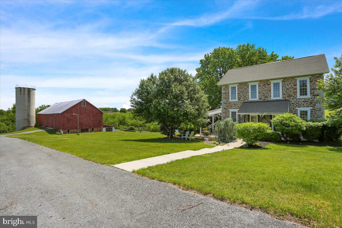 Step back in time and experience the charm of this circa 1800 stone farmhouse, offering 2,790 square feet of beautifully maintained living space on a breathtaking 44.23-acre property.
This historic 4-bedroom, 1.5-bath home blends timeless character with thoughtful modern updates, including gorgeous hardwood flooring throughout, a walk-in shower in the main bath, and a cozy wood stove in the basement sitting area—perfect for relaxing evenings.
The heart of the home is a gourmet kitchen featuring a propane gas cooktop, dual electric convection wall ovens, dishwasher, trash compactor, and garbage disposal—ideal for both everyday living and entertaining.
Adding to the property's versatility is an updated springhouse overlooking a tranquil spring-fed pond. This charming guest cottage includes 2 bedrooms, a full kitchen, dining room, living room, and a single bathroom—perfect for guests, extended family, or potential rental income.
Equestrian enthusiasts will appreciate the impressive 85' x 50' bank barn, with an upper level ideal for equipment storage and a lower level updated with four top-of-the-line horse stalls, including a dedicated birthing stall and a 17' X 14' office area. Additional features include an 80' x 40' pole building and three fenced pastures, offering ample space for horses or other recreational uses. The scenic open space and endless potential for outdoor enjoyment make this location truly unique..
The serenity of this property is second to none, offering a rare combination of historic charm, modern amenities, and peaceful surroundings. Whether you're seeking a private country retreat, equestrian haven, or a unique investment opportunity, this one-of-a-kind estate is a must-see.