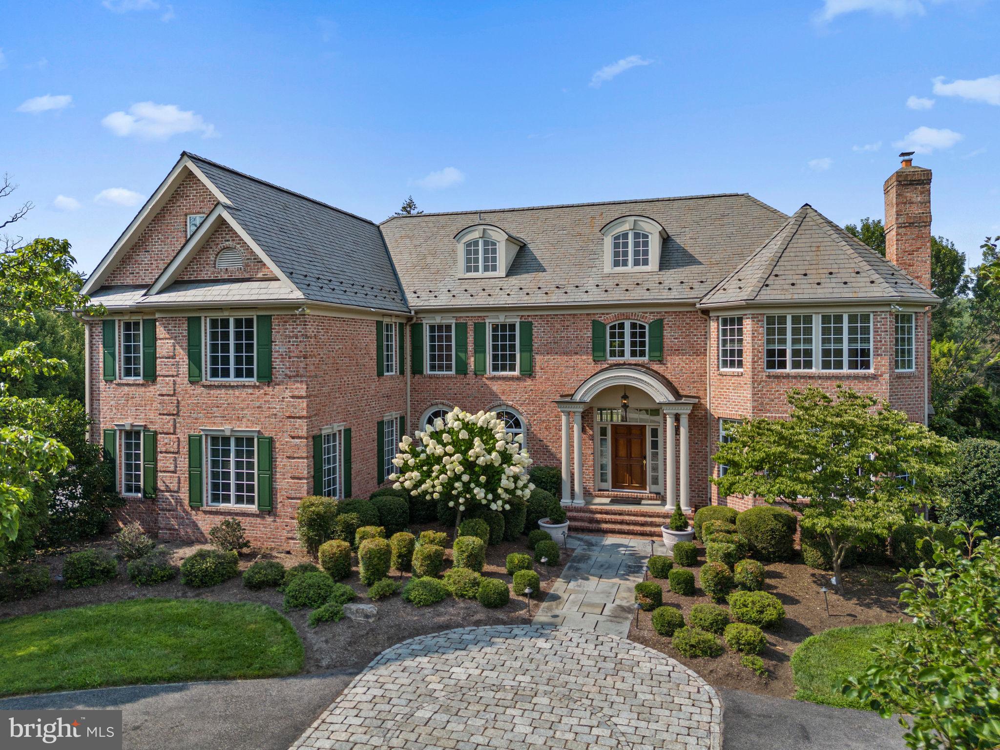 Welcome to 1 Dovecote Lane a stately 6-bedroom, 8.5-bathroom home nestled on two beautifully landscaped acres in highly sought-after Willistown Township. From the moment you step into the grand foyer—with limestone flooring, raised panel wainscoting, and a curved staircase—you’ll feel the craftsmanship and attention to detail that define this exceptional home. To the right of the entry, a formal living room showcases custom built-ins and gas fireplace with a marble surround and detailed millwork mantle. To the right, the dining room features crown molding, a tray ceiling, and classic raised panel wainscoting with recently installed custom wall paper and plantation shutters — perfect for elegant entertaining. The soaring great room is a showstopper, with a two-story coffered ceiling, floor to ceiling stone hearth wood-burning fireplace, and custom built-in bookcases. A cozy sunroom just off this space provides a quiet retreat with abundant natural light. The gourmet kitchen is designed for serious chefs and the home cook, featuring granite countertops and backsplash, a Sub-Zero refrigerator, Wolfe range, ample storage and a butler’s pantry complete with sink and wine cooler. Easily accessed from the breakfast room adjacent to the kitchen, don’t miss the fantastic exterior spaces – a Trex deck overlooks the fully-fenced level rear yard and just a few steps down to the bluestone patio with built-in grill and cooking area, the entertainer’s dream. Off the main living space, you’ll find the richly appointed study which boasts custom cherry cabinetry, crown molding, wainscoting, and a gas fireplace with a marble surround and cherry mantel. The main level is completed by access to the 4-car oversized garage, main level half bathroom, main level full bathroom just off the mudroom, a walk-in pantry, and a large laundry room. Upstairs, you’ll find the spacious primary suite which includes a private sitting room, tray ceiling, and a spa-inspired bath with marble floors, granite-topped vanities, custom cabinetry, a whirlpool tub, oversized shower, private water closet, and his and hers walk-in closets and dressing area. The remaining 4 bedrooms on this level are all generously sized each with its own en-suite bath featuring designer tile, Kohler fixtures, and custom-fitted closets. The third floor offers even more living space with a sixth bedroom, full bath, and a separate sitting area—perfect for guests or extended family. The finished lower level is an entertainer’s dream: a custom bar; a spacious recreation/game room; a home theater with updated state of the art home theatre movie projector with brand new speakers, amp and sound system; a full bath; and walk-up access to the rear yard. The lower level also offers a beautiful dance room with mirrored walls and a professional grade, cherry wood, sprung dance floor and home gym. Don’t miss other notable features since the home’s last time on the market: 2 20k natural gas generator systems with two service plans, wrought iron fully fenced rear yard, latex-coated garage floor, wifi-controlled outdoor lighting and thermostats, new water heater (2025), new 1st floor HVAC system, updated paint and light fixtures. This home offers the perfect blend of elegance, functionality, and comfort and is just minutes to Malvern Borough and major travel routes.