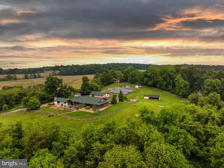Live authentically. Cedar Crest Farm. Discover a sanctuary where authenticity meets tranquility. Embrace the road less traveled and look forward to meandering through serene country lanes, enveloped by towering trees, leading you to your haven. You have arrived at your equestrian estate. Channeling an enduring Jackson Hole Mountain aesthetic, perched on 19.67 enchanting acres with panoramic big sky views...you won't want to leave. 
Be greeted by a soothing neutral palette and exquisite millwork that showcases superior craftsmanship throughout. Expanses of glass and open spaces frame the beauty surrounding you. Step outside to a 140-foot wraparound covered loggia that terraces to an elaborate 80-foot-long incredible deck, perfect for taking in breathtaking sunsets and sunrises. Enjoy leisurely evenings under the stars on your stunning terrace. The tranquil fountain sculpture, "Coming Together", by Aristides Demetrius, is as remarkable as it is soothing. Let scintillating conversation flow freely by the cozy fireplace and inviting fire pit—ideal for gatherings and quiet reflection alike.
Behold the party barn of all party barns. Three stories of jaw-dropping exposed beams, soaring ceilings and a plethora of possibilities. Complete with its own kitchen, bath and dedicated bedroom space.
For the riding enthusiast, there's an impressive 200x90, 18,000 square foot indoor riding arena where the lights come on instantly. There are mirrors covering the back wall and the walls are canted for safety. No detail is overlooked. The footing is a comfortable mix for horses including bits of tire. Ride effortlessly from the indoor to your outdoor riding arena, complete with jumps and jump storage. There is also a full cross-country course on the property. This includes coops, bank jumps, tables, corners and everything a rider desires. Eight stalls in the bottom barn, one of them currently used as the wash stall equipped with hot and cold water and heat lamps. The upper barn offers a multitude of possibilities due to its spacious and versatile nature...it currently has two stalls. Ample garage space at the house and down at the barn could make an easy conversion to more stalls if needed. The hay shed holds 500+ bales of hay. Ideal for anyone looking to enjoy and utilize a well-equipped equestrian facility, whether for personal use and beyond. Additional features include run-ins and an accessible stream through the bottom fields with a charming bridge. Indulge in luxury with a lap pool and hot tub, providing year-round relaxation and wellness. The lush greenery encircling the property enhances the sense of seclusion and peace. This property is not just a farm, but a lifestyle—a place where every day feels like a retreat. Cultivate your existence. The art of uniting human and home.