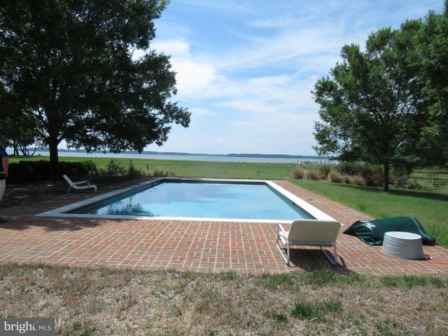 Exceptional Waterfront estate building site. 15.6 acres with over 964+/- feet of high protected shoreline. Dock includes boat lift and additional slip with 4 feet MLW water. This property has a well, inground Gunnite pool, and driveway; at one time there was a 6 bedroom home here that was destroyed in a fire but underground utilities and improvements still remain. Broad open views over broad creek and out over the Chesapeake Bay. This is a private estate area with few properties this unique. 100ft setback is staked out.